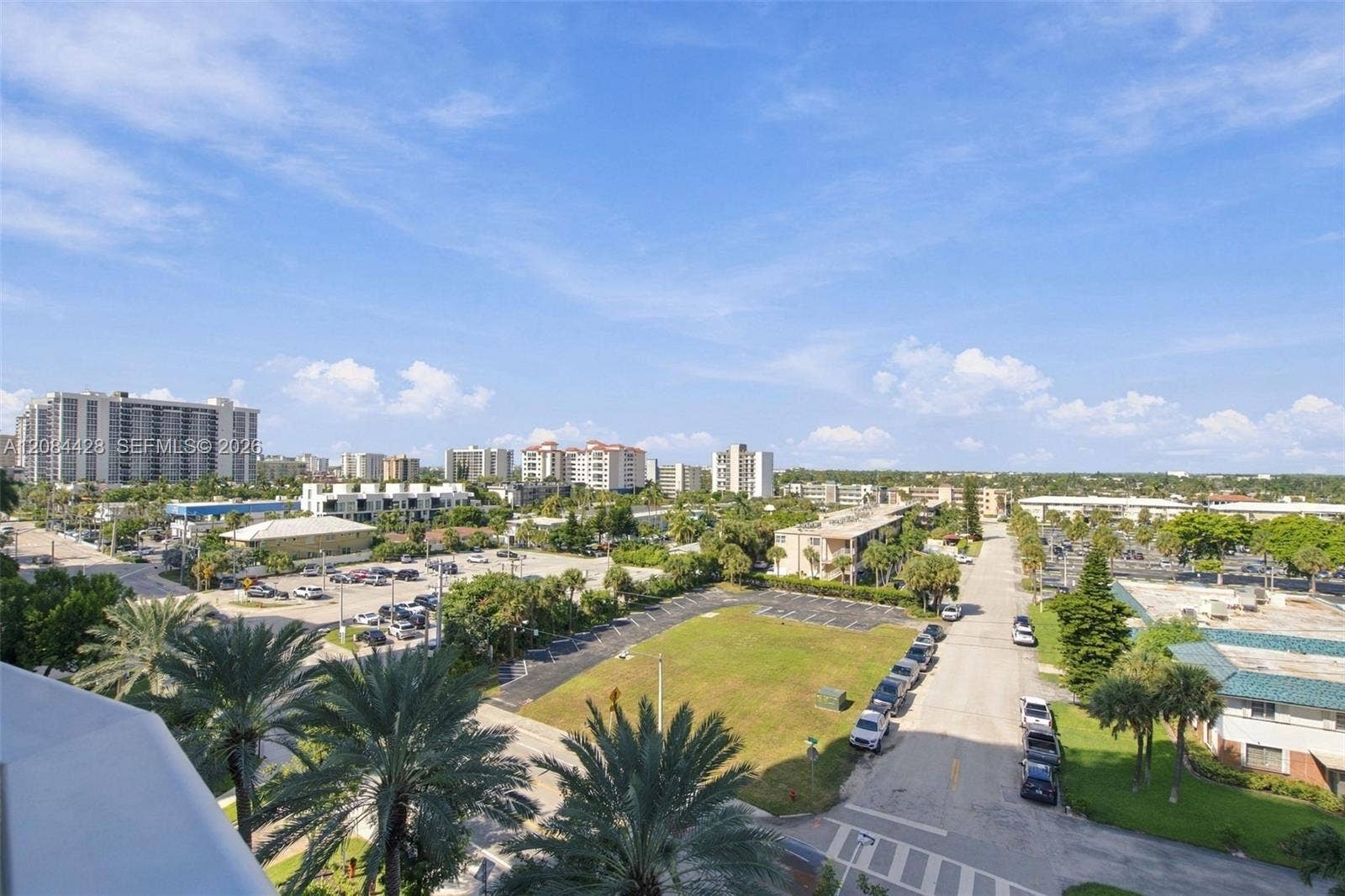 730 N Ocean Boulevard, #601, Pompano Beach, Pompano Beach, FL 33062 View from the balcony overlooking the Intracoastal, surrounding cityscape, and lush grounds.