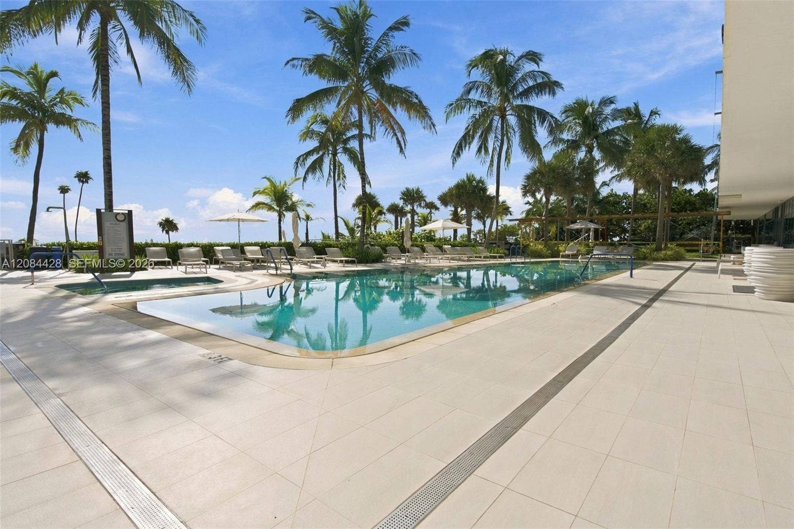 730 N Ocean Boulevard, #601, Pompano Beach, Pompano Beach, FL 33062 Resort-style swimming pool surrounded by palms and ample sun deck seating.