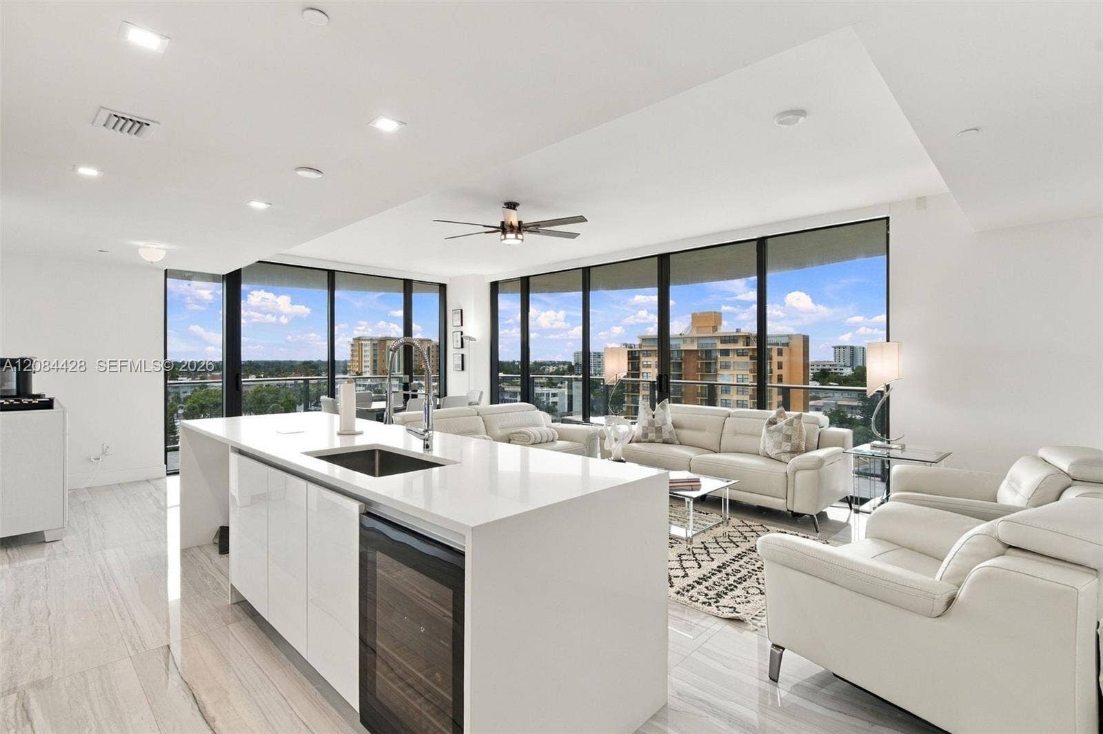 730 N Ocean Boulevard, #601, Pompano Beach, Pompano Beach, FL 33062 Open-concept kitchen with waterfall island, wine/beverage refrigerator, and adjoining living area.