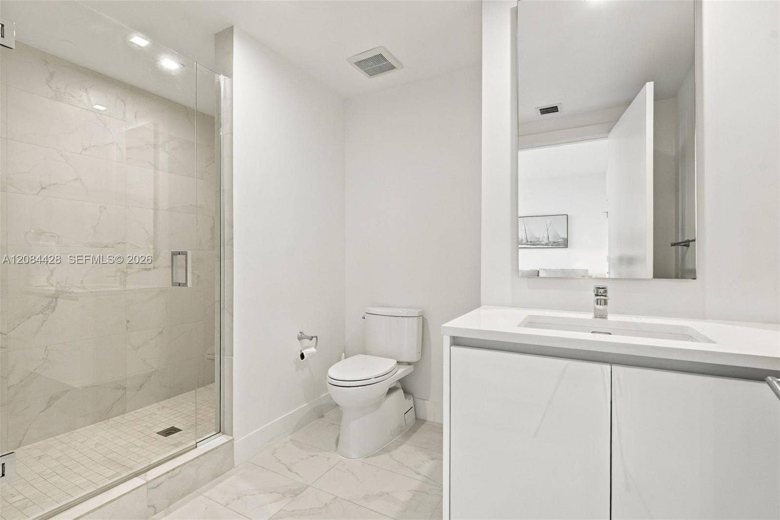 730 N Ocean Boulevard, #601, Pompano Beach, Pompano Beach, FL 33062 Guest bathroom with a glass-enclosed walk-in shower.