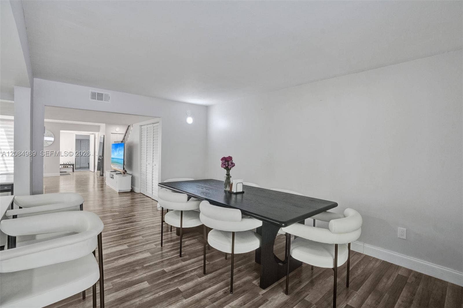 Neutral interior space featuring wood-finish flooring and bi-fold closet doors