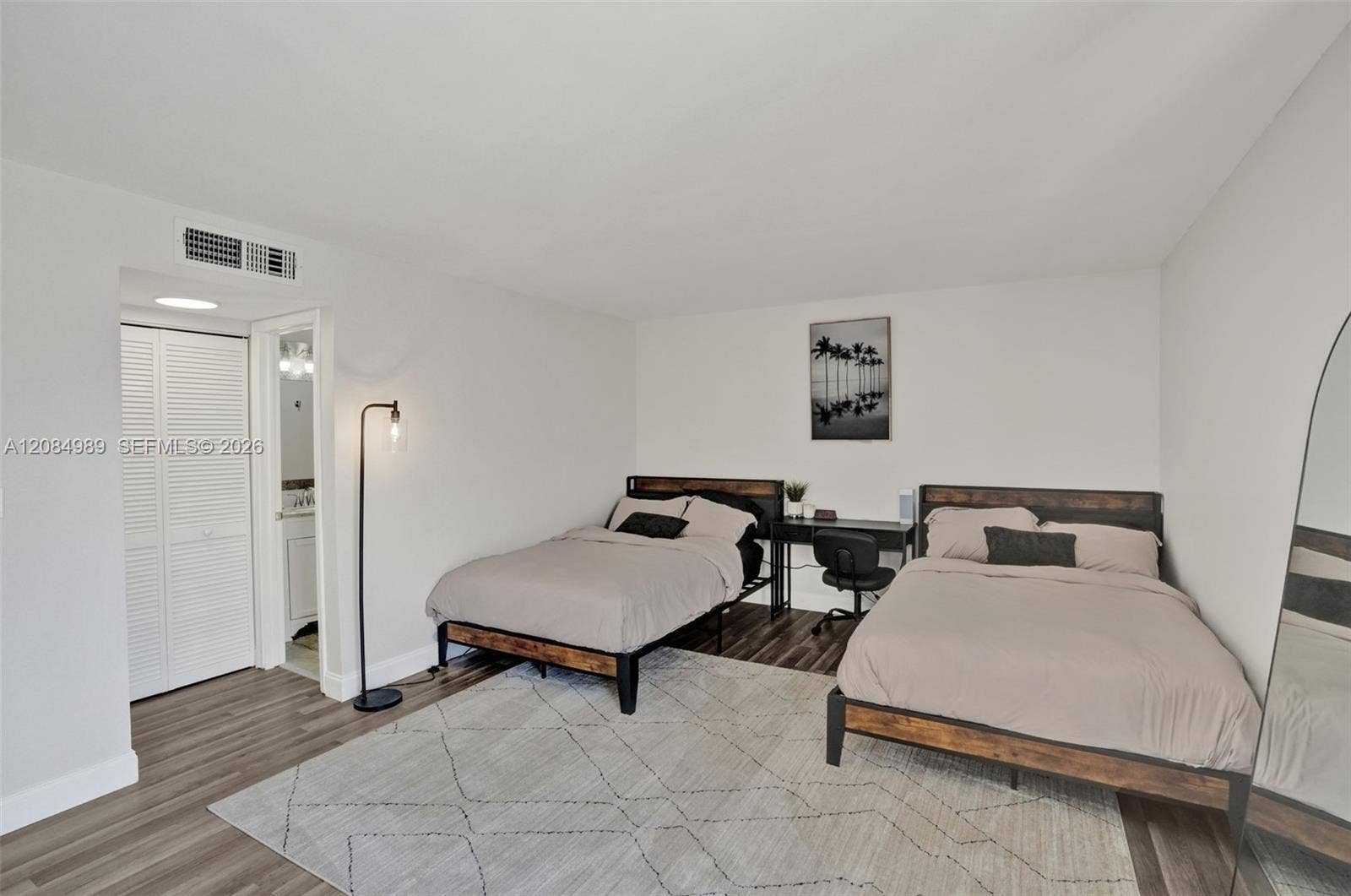 Room featuring wood-finish flooring and a double-door closet