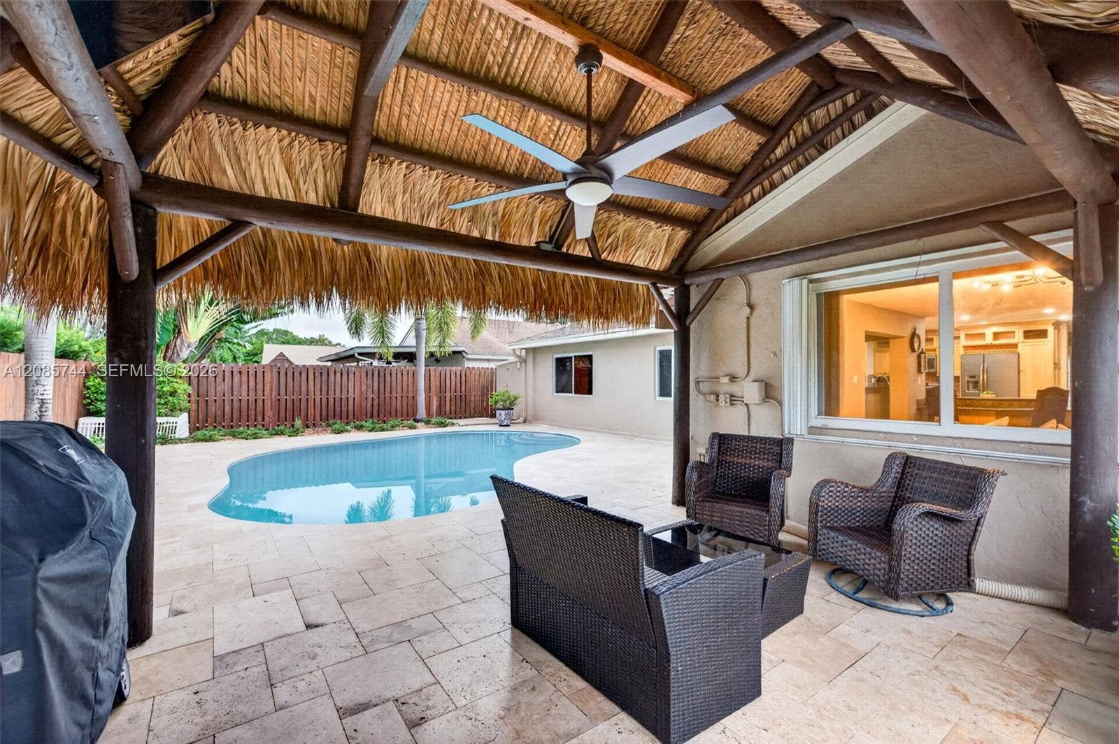 Gorgeous recently resurfaced pool w/ travertine decking, fully fenced, w/ amazing tiki hut, recently rethatched and new sprinkler pump