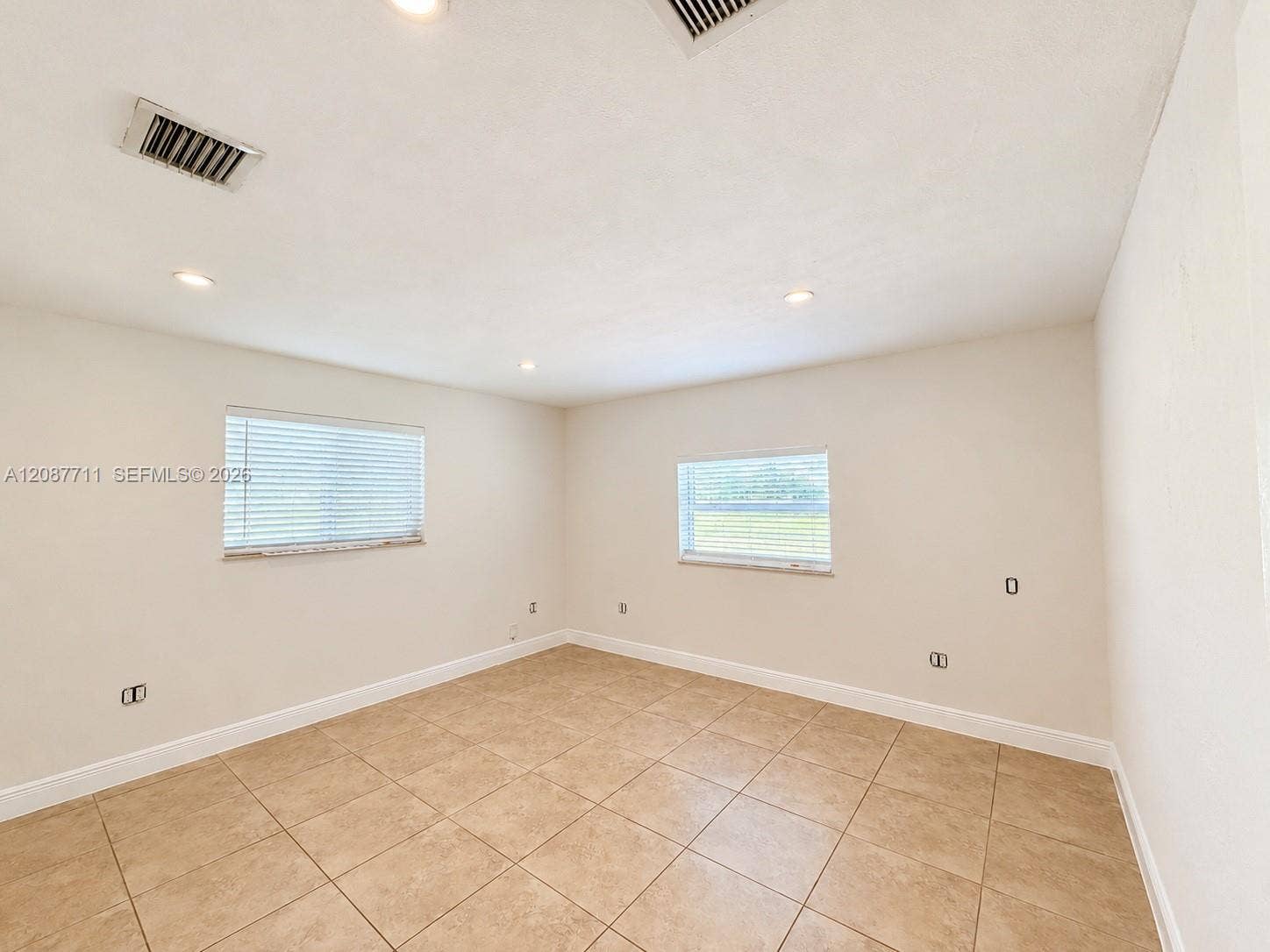 80 NE 162nd Street, Miami, Miami, FL 33162 Neutral-toned tile flooring, recessed ceiling lighting, and dual windows with horizontal blinds
