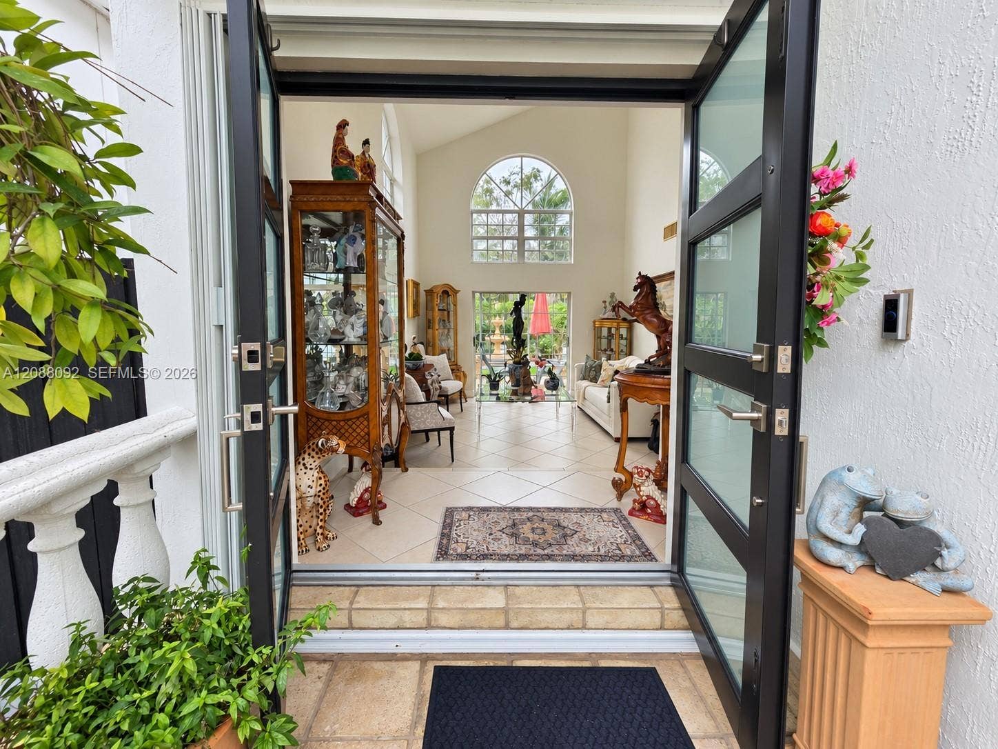 Double impact doors into foyer followed by Living Room
