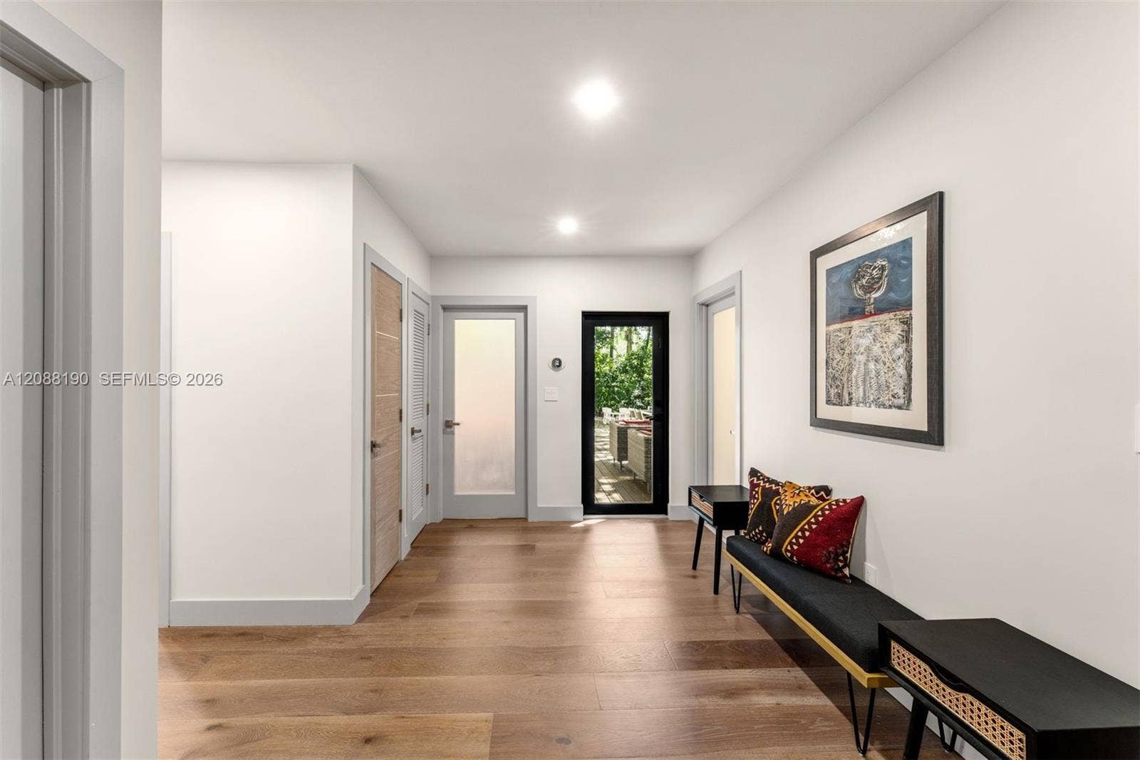Bedroom wing common area with closets for studio or library