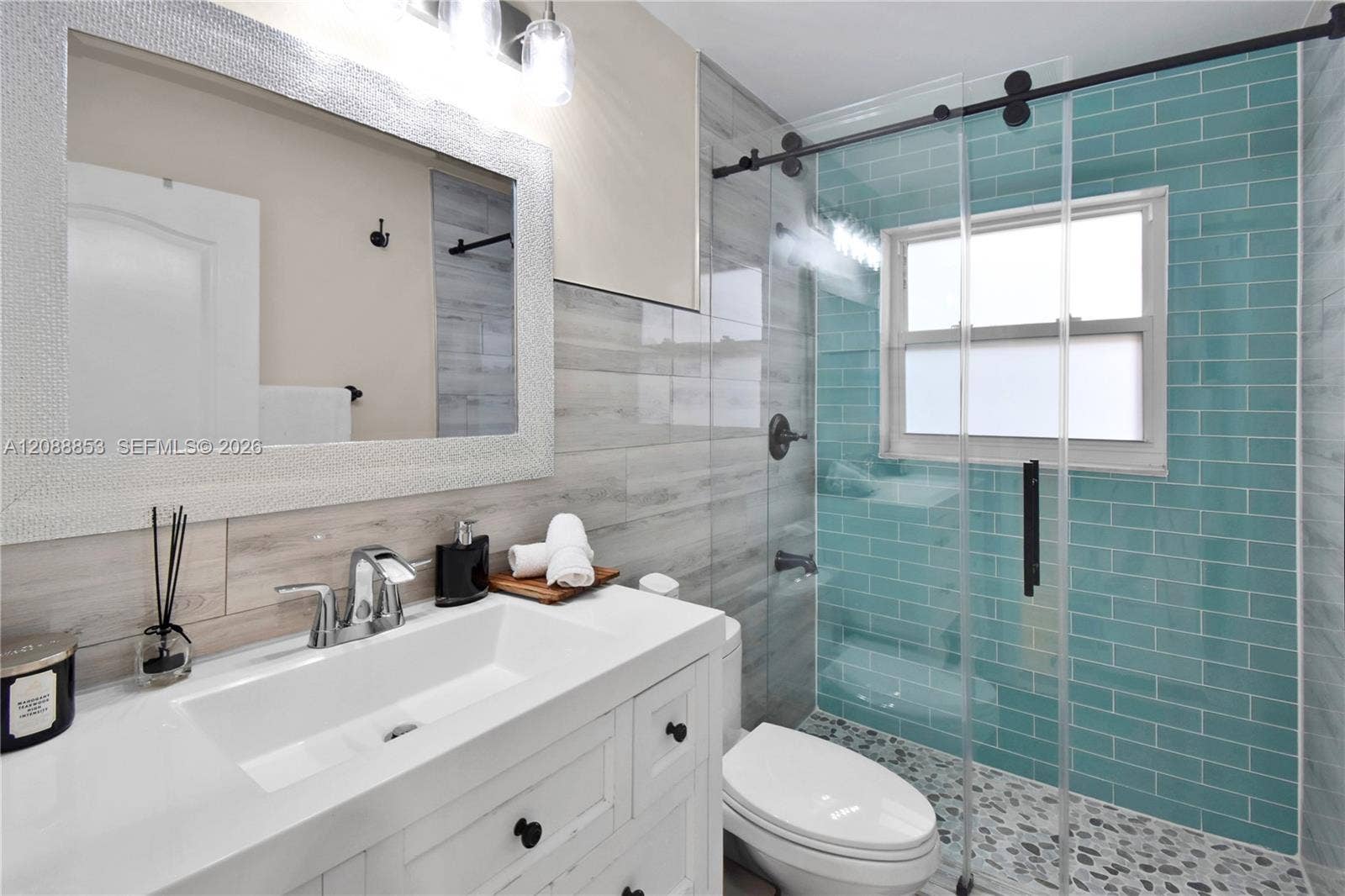 523 Stonemont Drive, Weston, FL 33326 Updated bathroom with new vanity and fixtures, and glass-enclosed shower