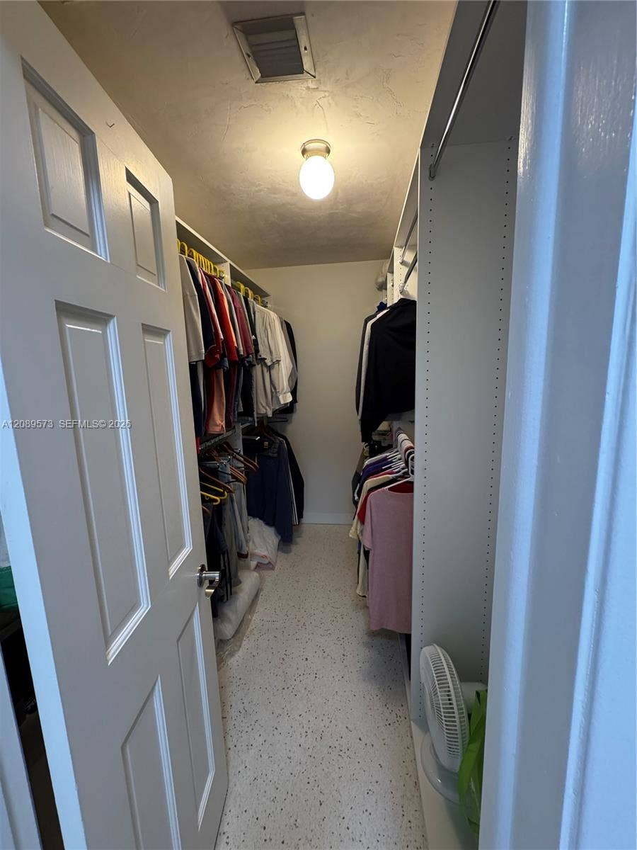 Custom shelving in primary BR walk-in closet.
