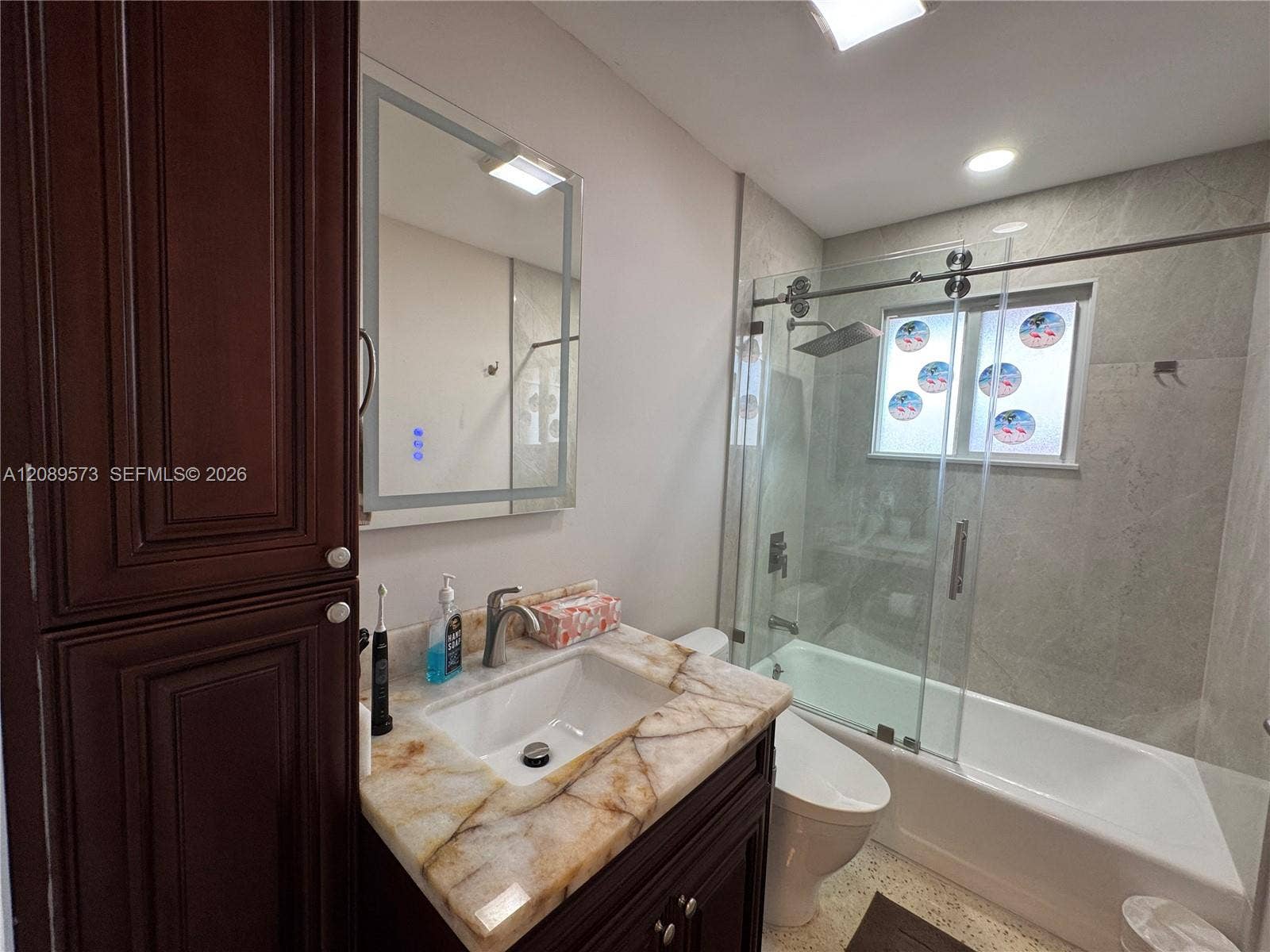 2nd Bathroom, custom shelving, marble top on vanity, beautiful tub/shower area with top of the line plumbing fixtures, plus Toto toilet.