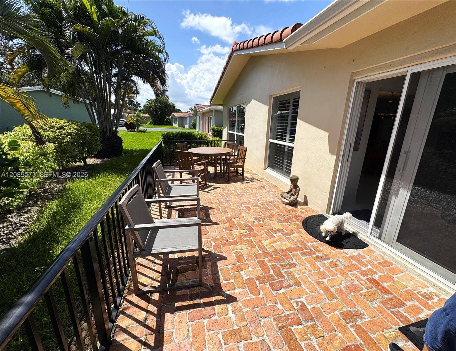 Beautiful custom brick patio with wrought iron fence w/gate around patio. South exposure on patio for fabulous breezes. Great area for entertaining, BBQ or relaxing!