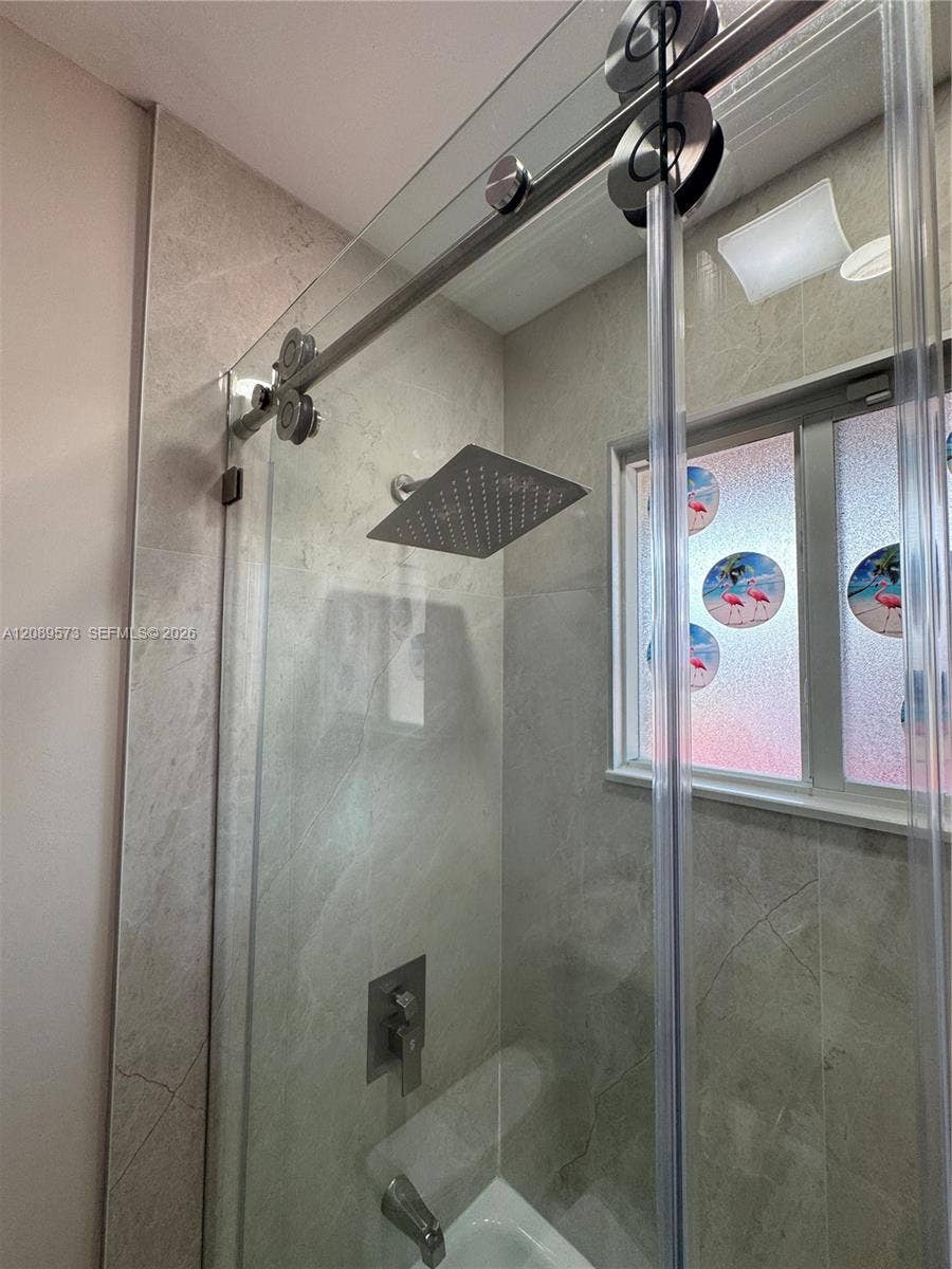 2nd Bathroom, custom shelving, marble top on vanity, beautiful tub/shower area with top of the line plumbing fixtures.
