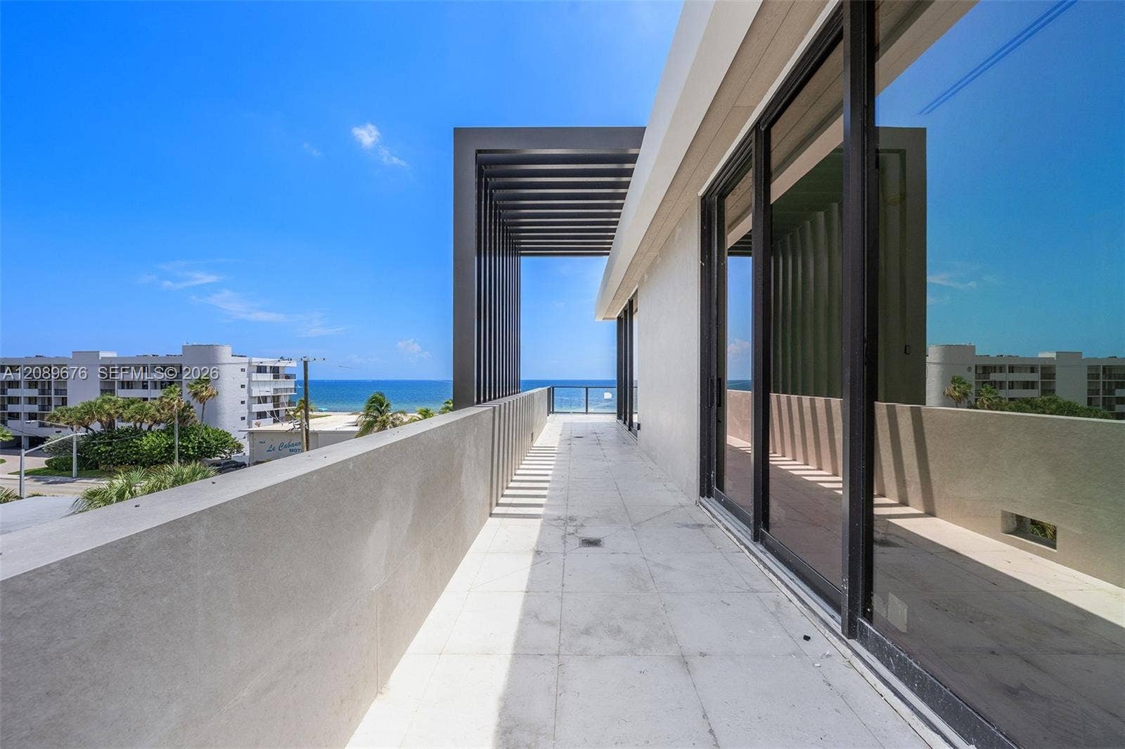 497 N Ocean Boulevard, #1, Pompano Beach, FL 33062 Fourth-floor terrace through the louvered pergola.