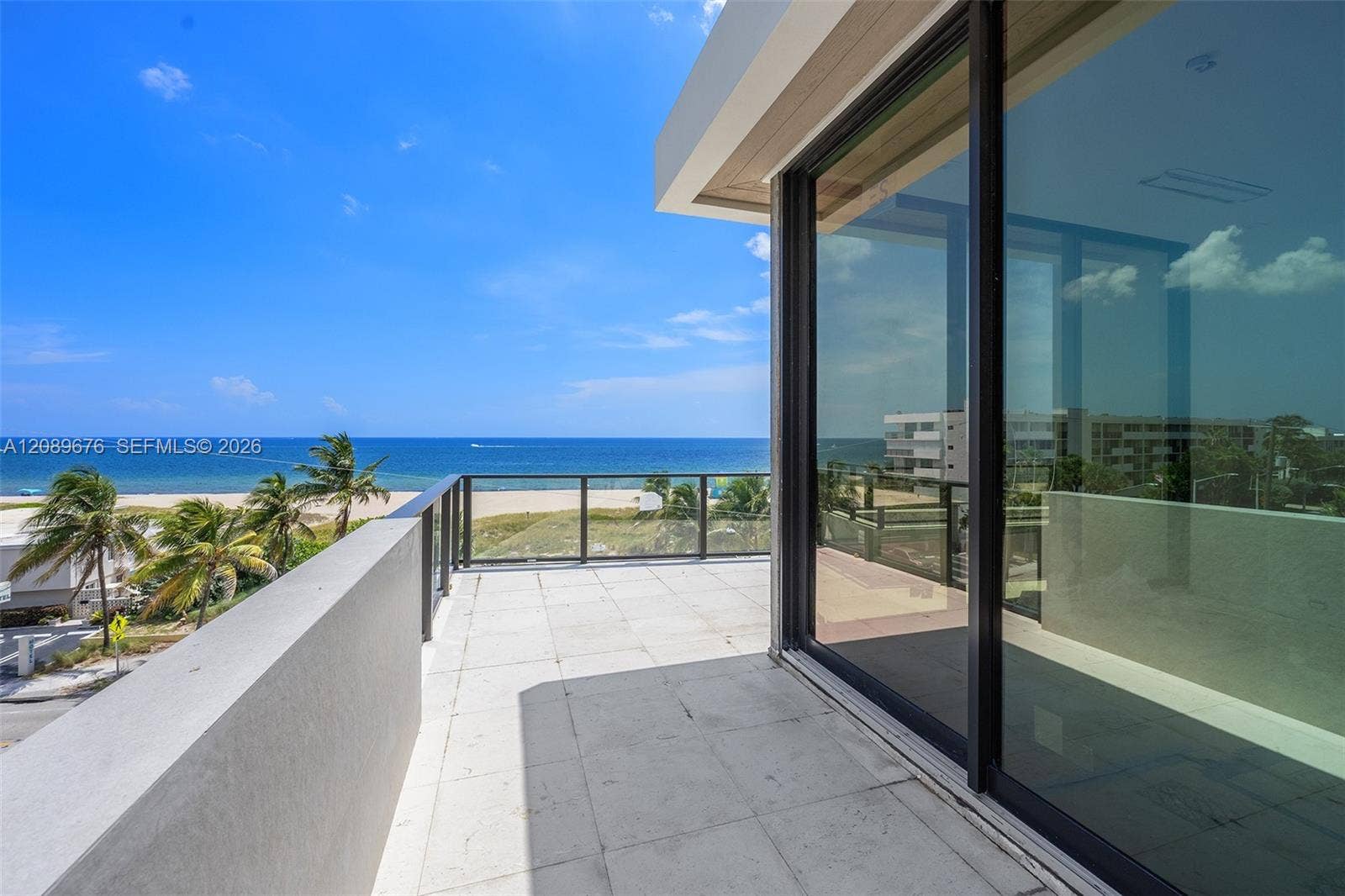 497 N Ocean Boulevard, #1, Pompano Beach, FL 33062 Fourth-floor terrace and glass wall.