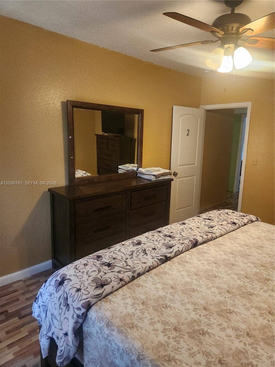 Multi-paneled interior door and ceiling-mounted fan with integrated light fixture