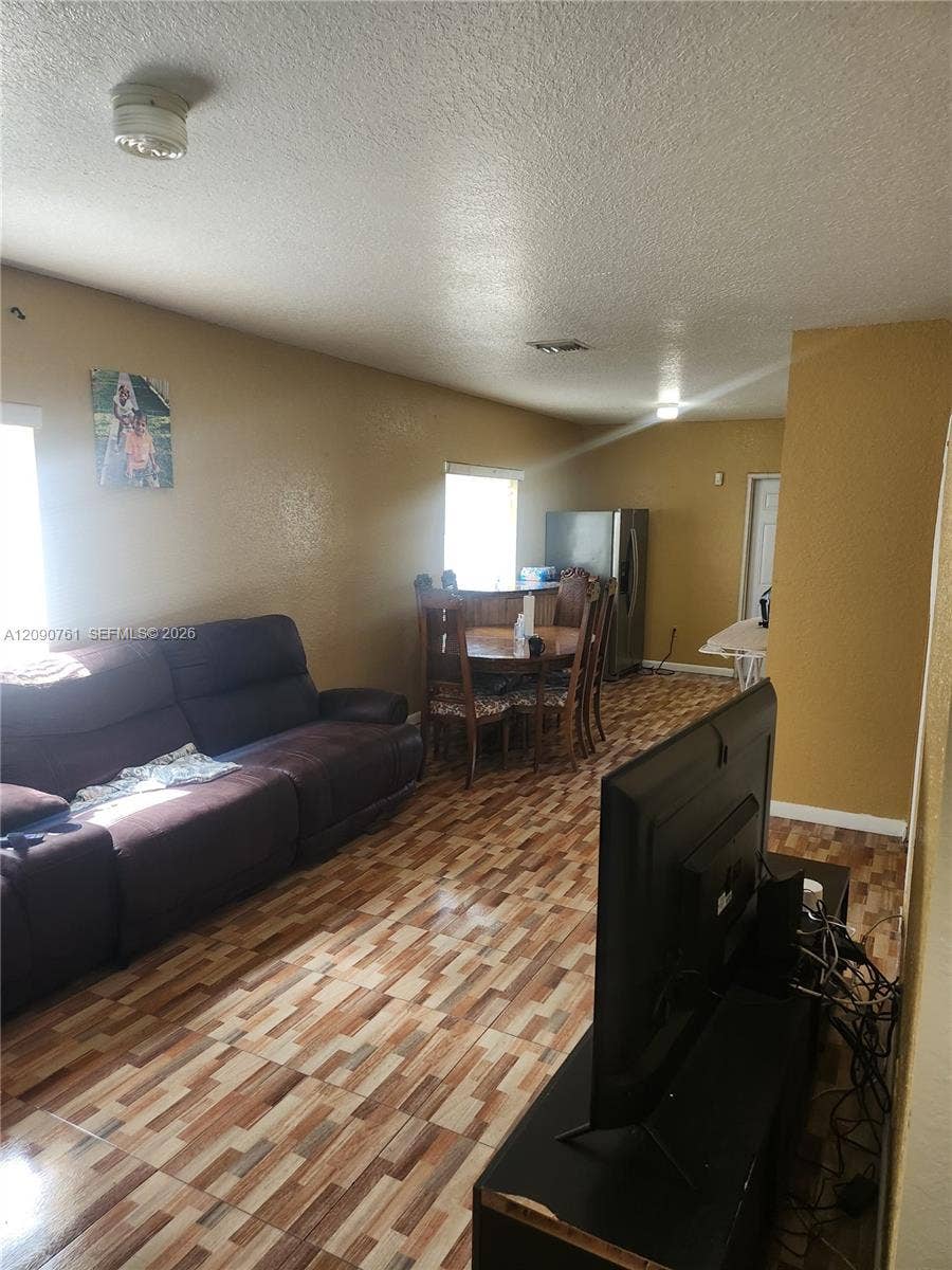 Multi-purpose area featuring patterned tile flooring and neutral wall paint