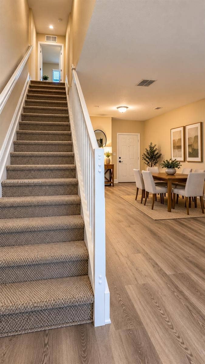2196 Ensenada Terrace, Weston, FL 33327 Stairway with carpeted treads and white wood railings