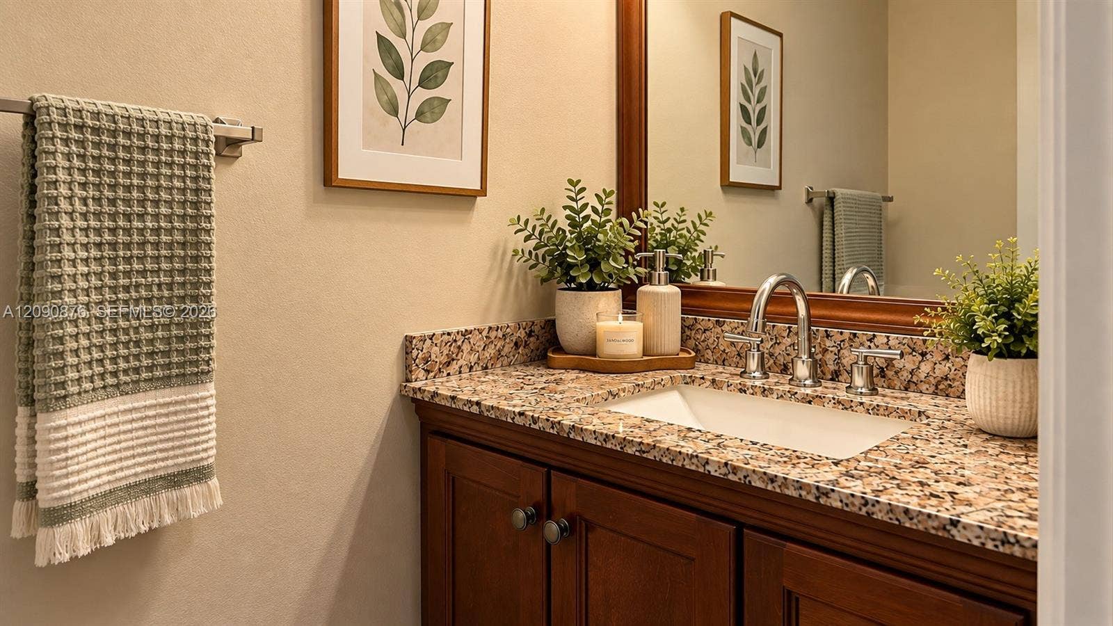 2196 Ensenada Terrace, Weston, FL 33327 Wood-finish vanity with an integrated basin, chrome two-handle faucet, and granite countertop