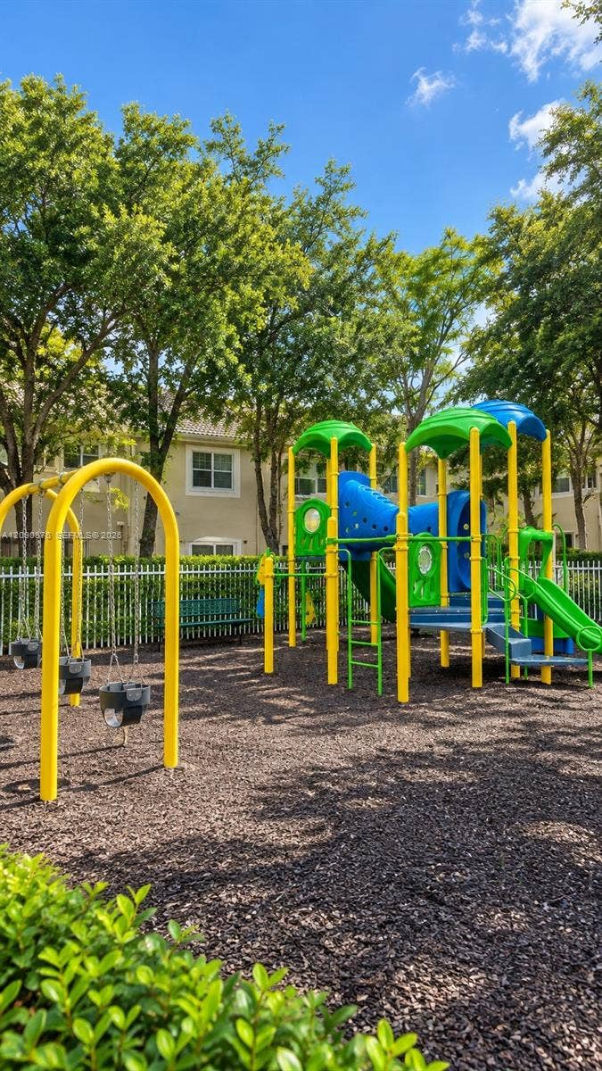 2196 Ensenada Terrace, Weston, FL 33327 Community playground featuring swings, slides, and climbing structures