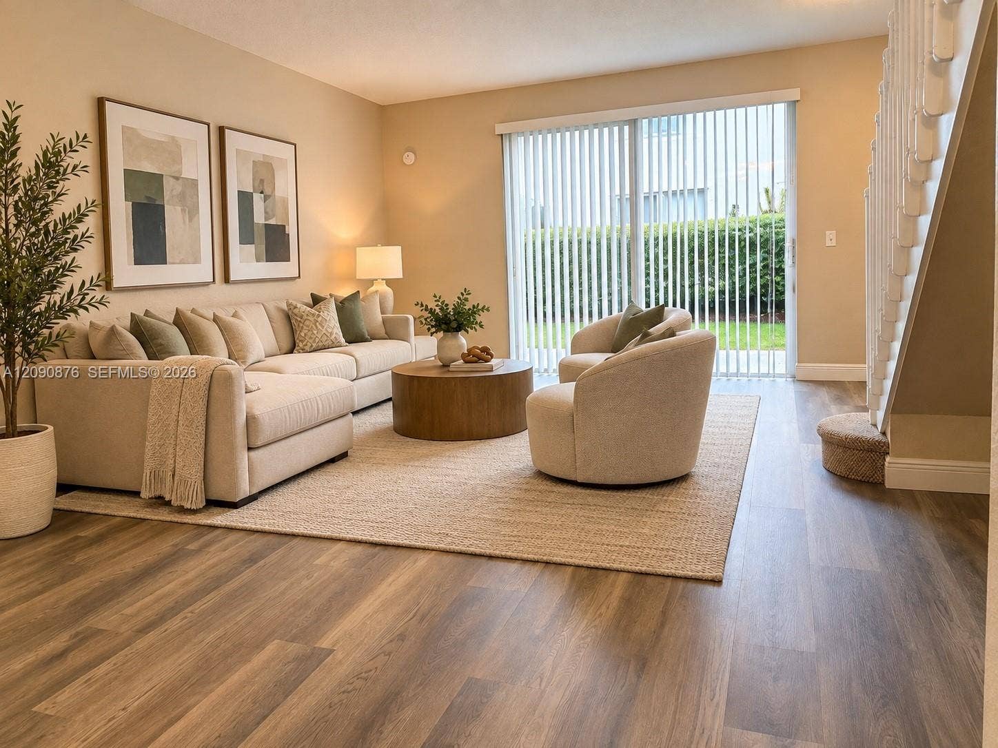 2196 Ensenada Terrace, Weston, FL 33327 Wood-finish flooring throughout, sliding glass door with vertical blinds, and a carpeted staircase with white railings