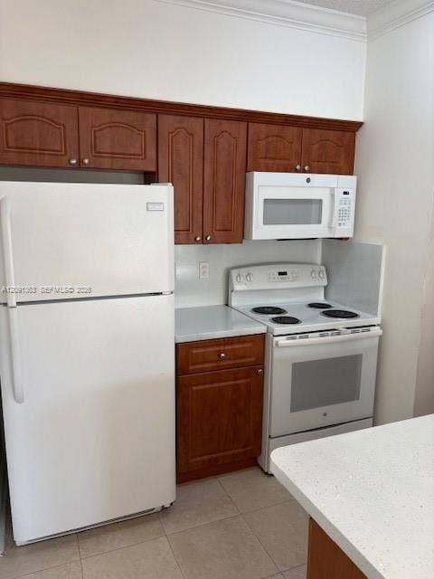 18356 NW 68th Avenue, #E, Hialeah, Hialeah, FL 33015 Kitchen featuring wood-finish cabinetry, solid surface countertops, white appliances, and tiled flooring