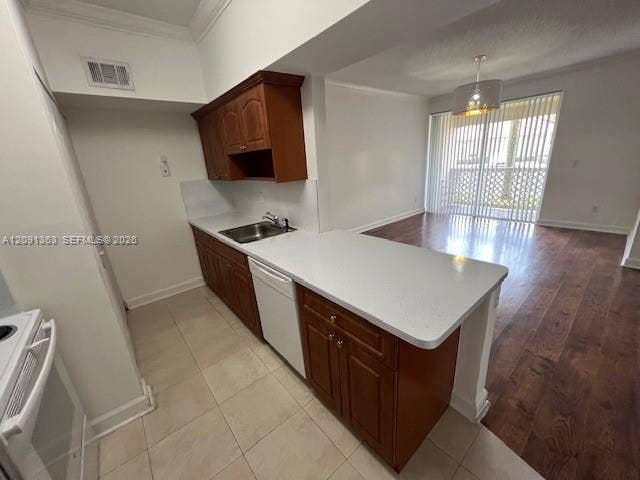 18356 NW 68th Avenue, #E, Hialeah, Hialeah, FL 33015 Kitchen featuring wood cabinetry, white solid-surface countertops, tile flooring, and wood-finish flooring in the open area with sliding glass doors