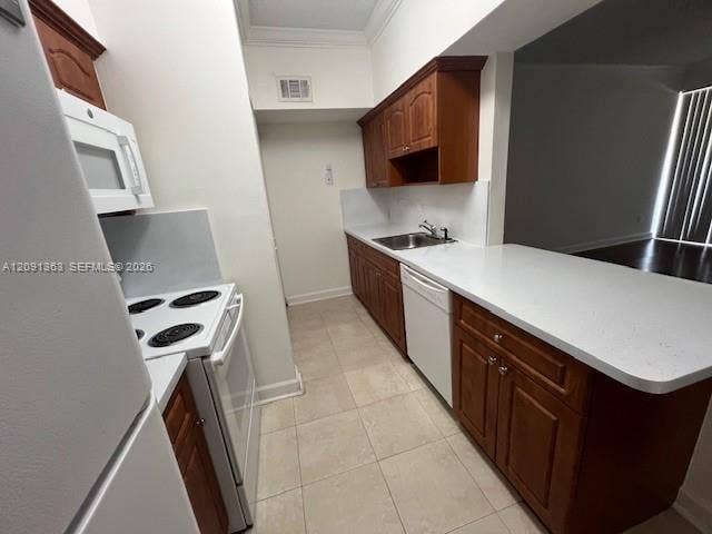 18356 NW 68th Avenue, #E, Hialeah, Hialeah, FL 33015 Kitchen featuring wood cabinetry, white solid-surface countertops, tile flooring, and integrated white appliances