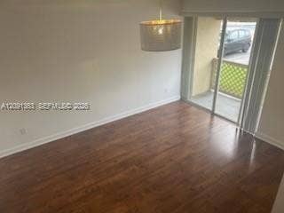 18356 NW 68th Avenue, #E, Hialeah, Hialeah, FL 33015 Wood-finish flooring, cylinder drum pendant lighting, and sliding glass door with lattice-patterned balcony railing