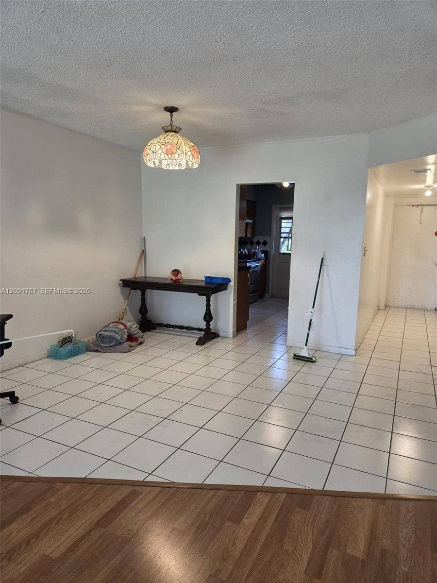 9101 W Sample Road, #102, Coral Springs, FL 33065 Ceramic tile flooring, drop-in decorative pendant lighting, and wood-finish flooring