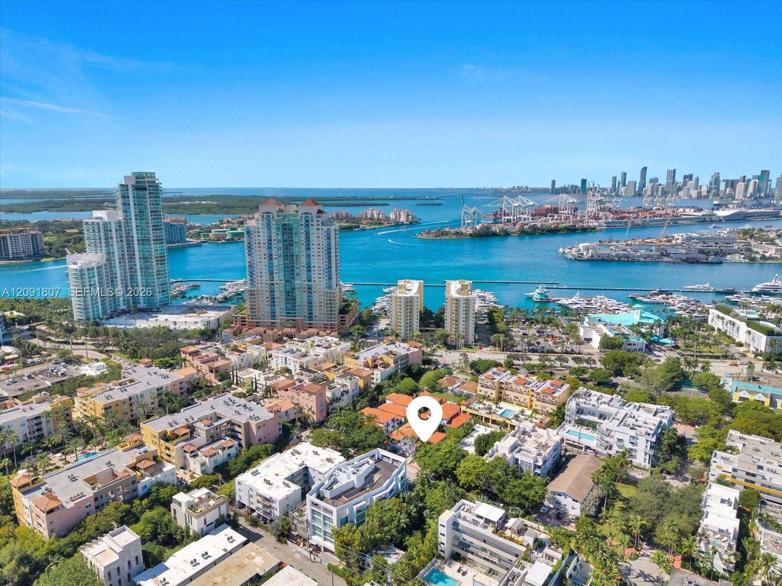 Aerial perspective featuring coastal surroundings, prominent harbor skyline, and multi-family residential development
