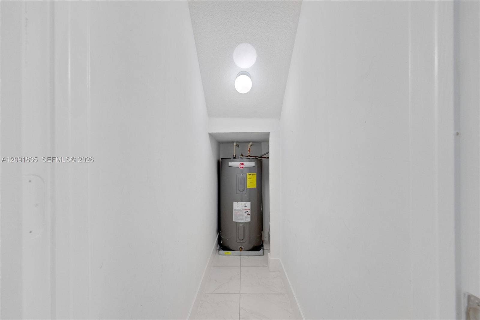 22409 SW 102nd Avenue, Miami, FL 33190 water heater, white tile flooring, and a ceiling-mounted light fixture