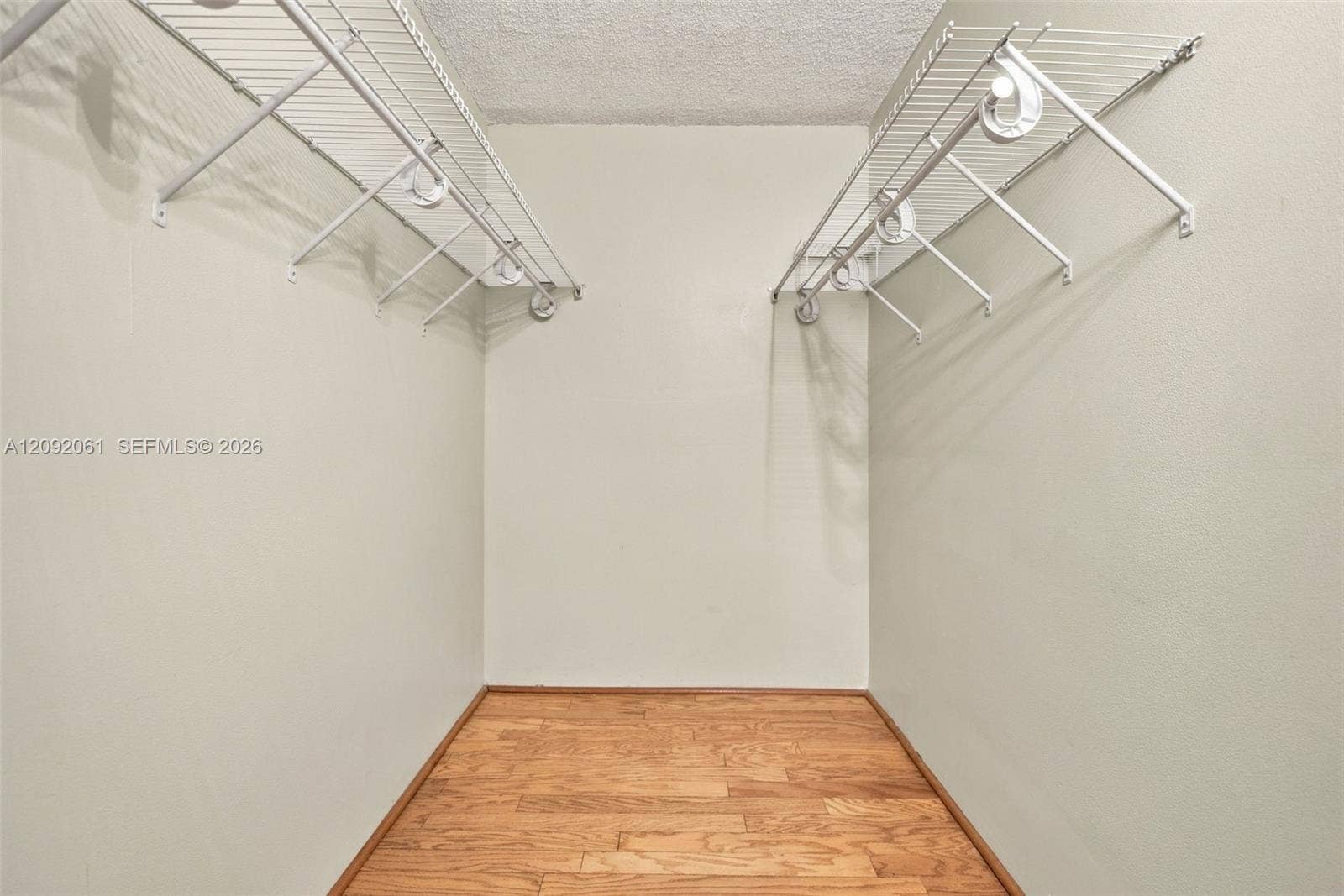 6555 W Broward Boulevard, #309, Plantation, FL 33317 Storage space featuring dual-level white wire shelving and wood-finish flooring
