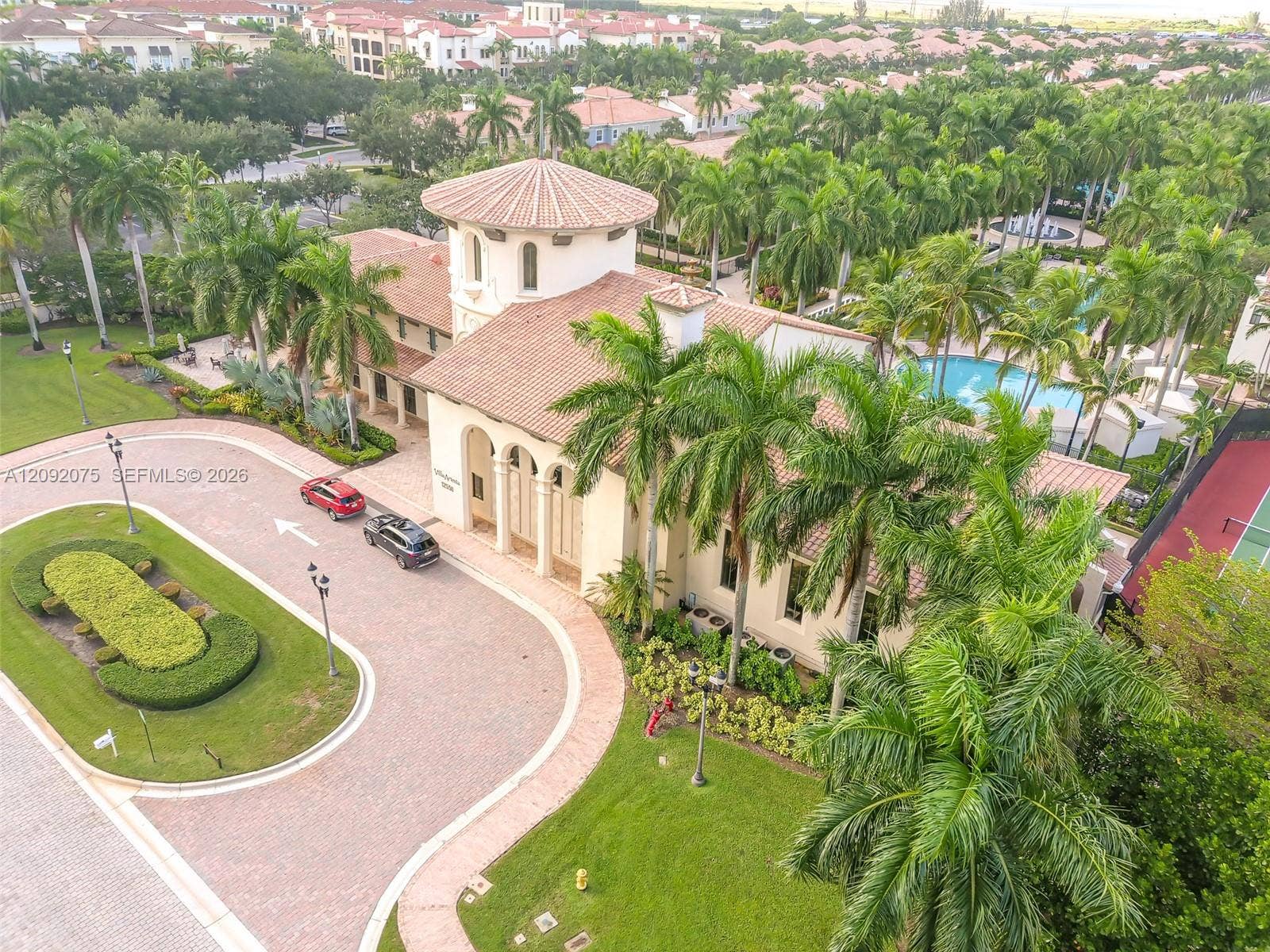 3055 NW 126th Avenue, #219, Sunrise, FL 33323 Mediterranean-style building with a tiled roof, central tower, and arched entryway