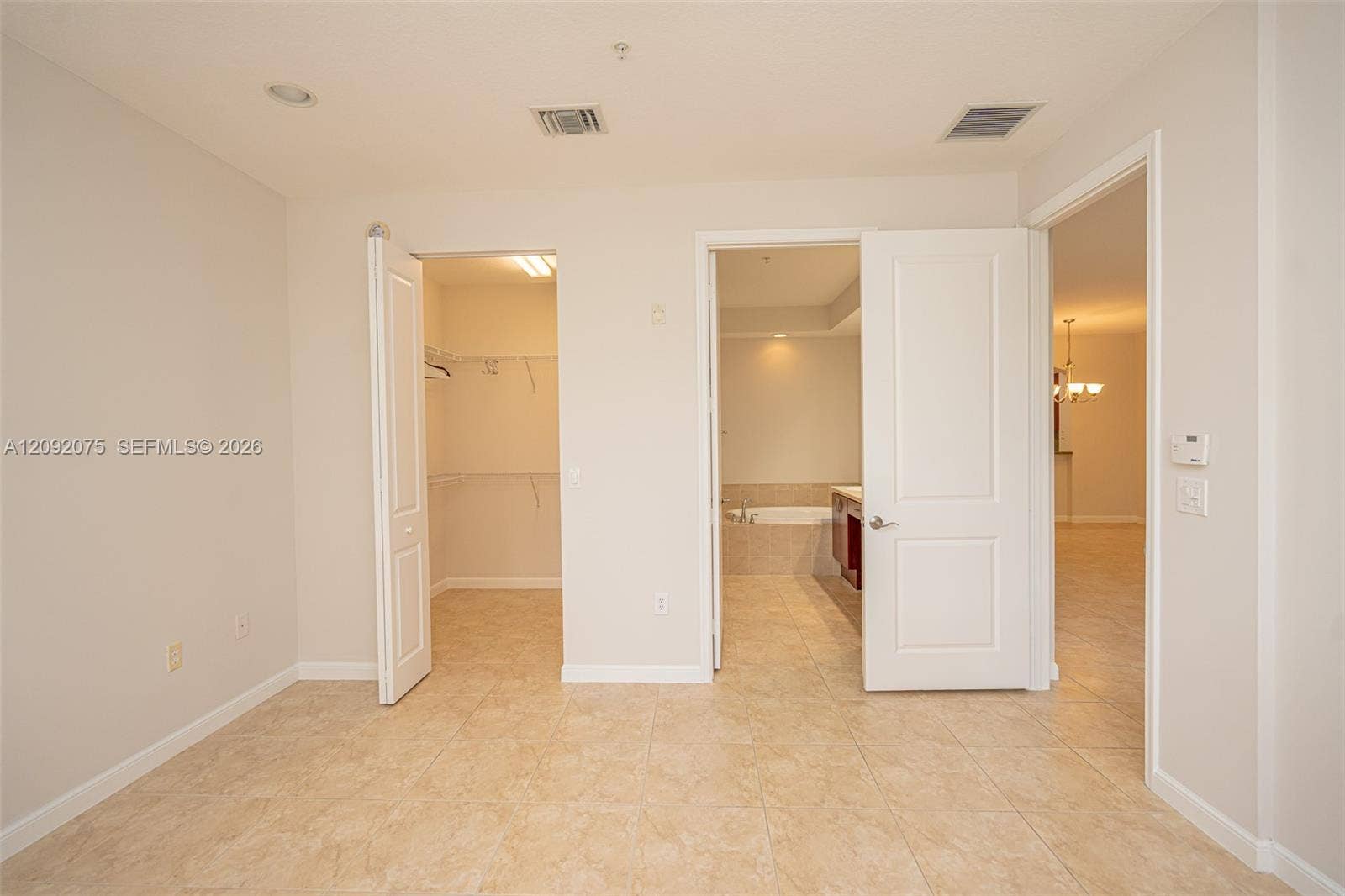 3055 NW 126th Avenue, #219, Sunrise, FL 33323 Tile flooring, recessed lighting, white interior doors, and a walk-in closet with built-in shelving
