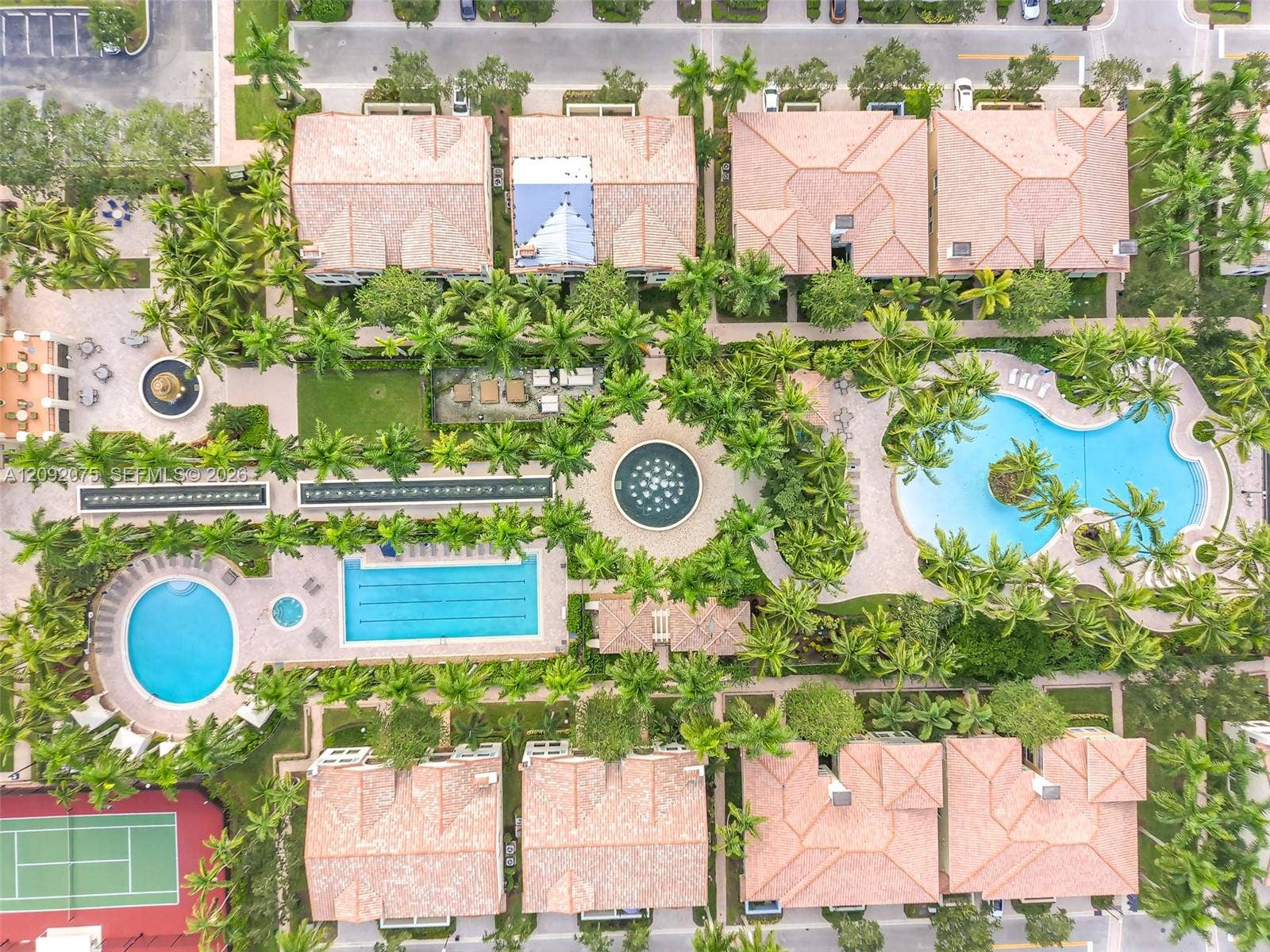 3055 NW 126th Avenue, #219, Sunrise, FL 33323 Community grounds featuring multiple pools, a tennis court, and lush landscaping