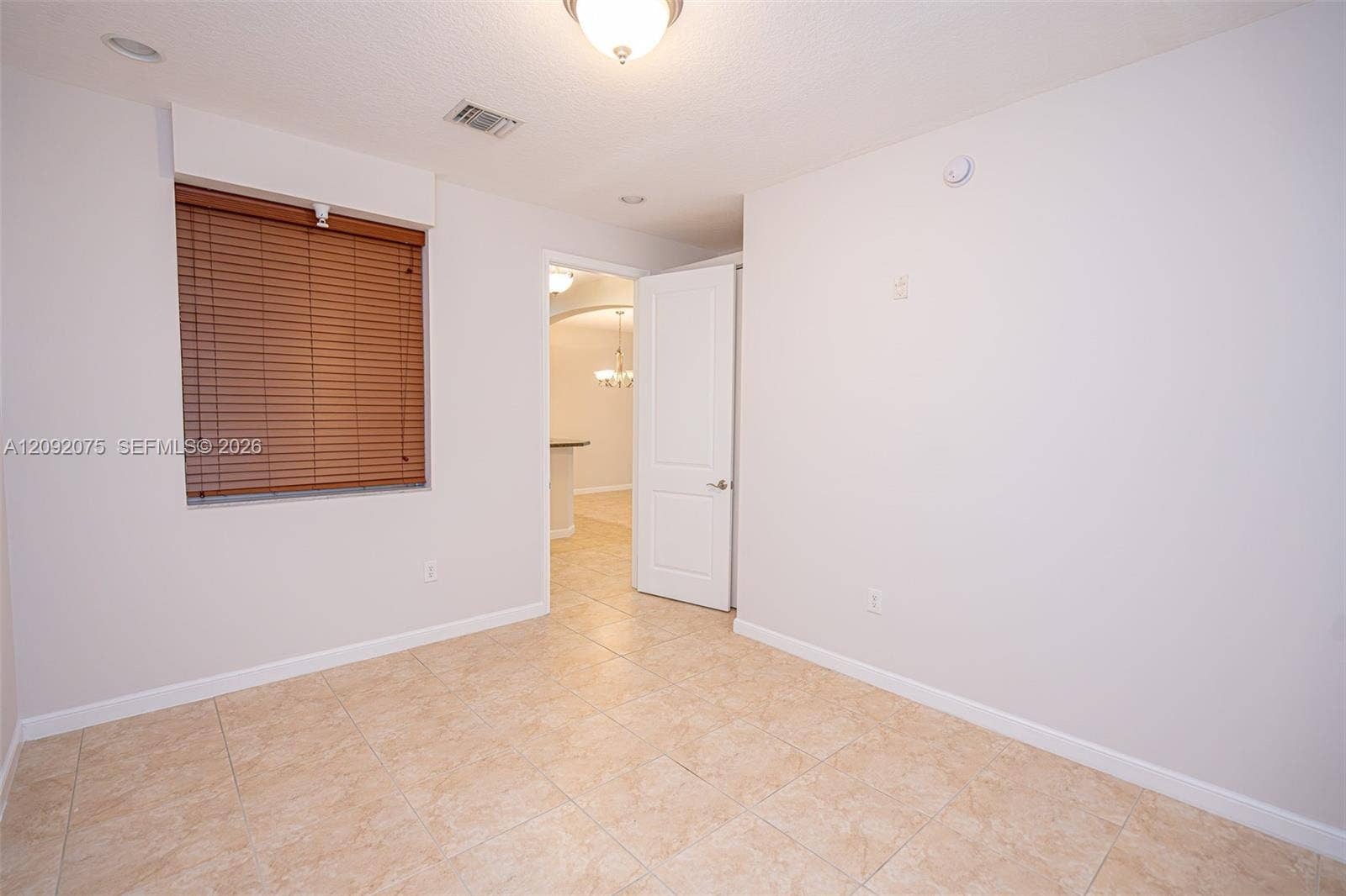 3055 NW 126th Avenue, #219, Sunrise, FL 33323 Recessed lighting, ceiling-mounted light fixture, tile flooring, interior door, window with wood-finish blinds