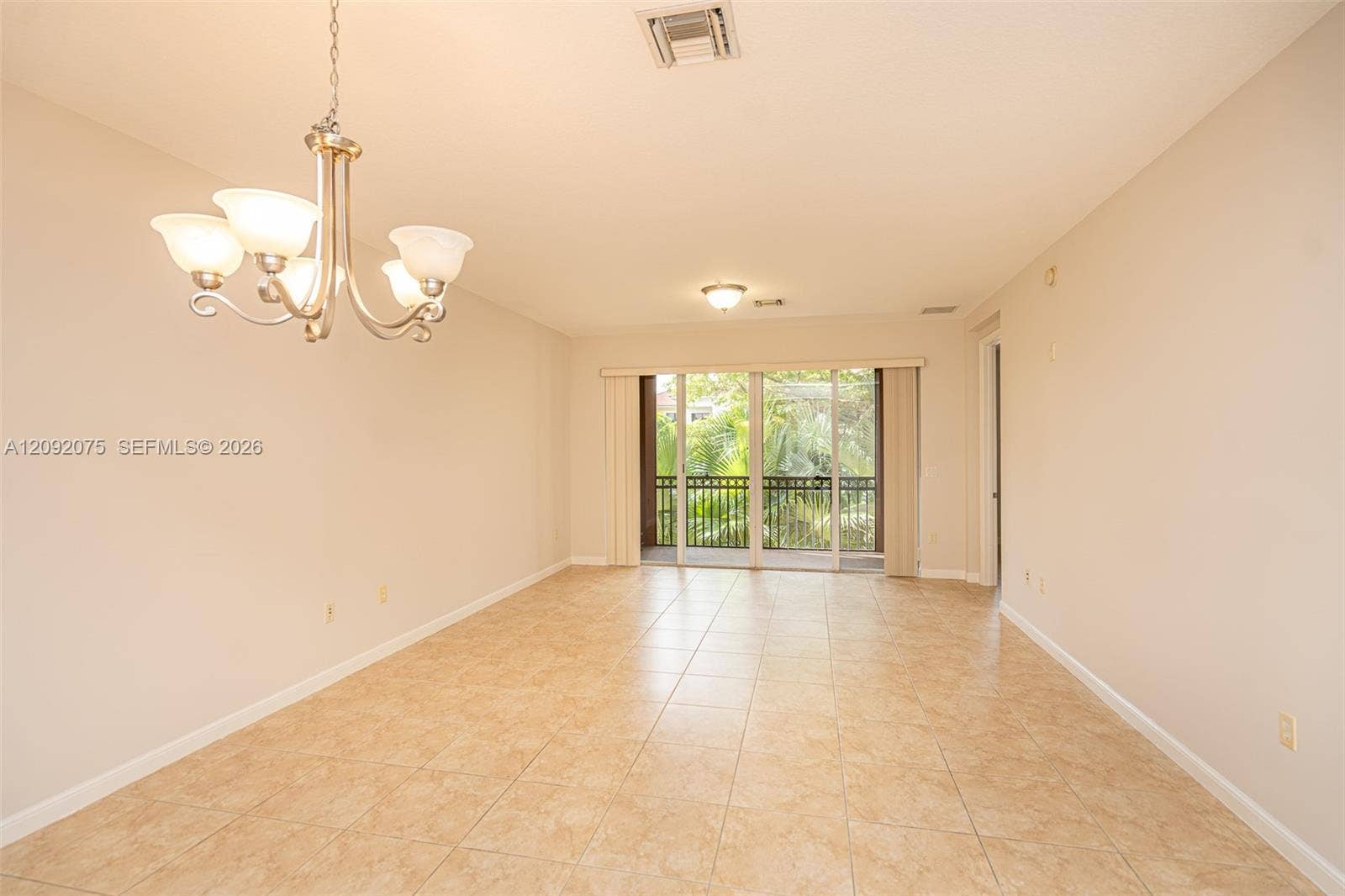 3055 NW 126th Avenue, #219, Sunrise, FL 33323 Neutral-toned walls and tile flooring create an expansive open-concept living area