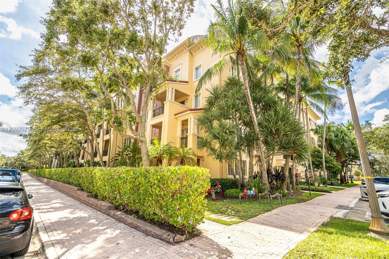 3055 NW 126th Avenue, #219, Sunrise, FL 33323 Multi-story residential structure with a stucco exterior, multiple private balconies, and a tile roof