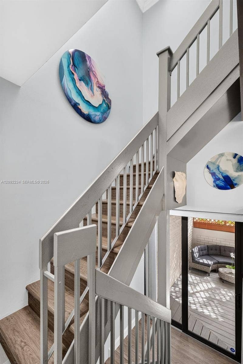 1401 NE 9th Street, #50, Fort Lauderdale, FL 33304 Gray Laminate Wood Flooring on the Stairs Adds to the Townhouse's Upscale Look and Well Lit with the Skylight Above the Stairs