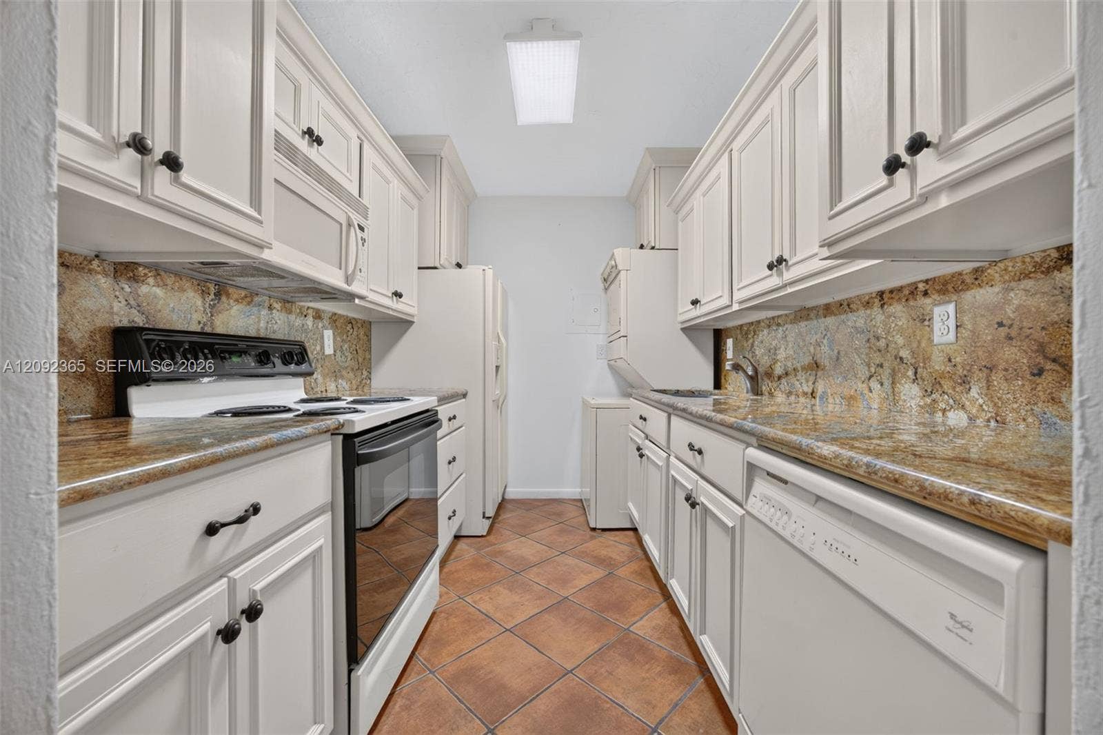 9356 SW 77th Avenue, #J7, Miami, FL 33156 Kitchen with wood cabinetry, granite countertops & WASHER DRYER