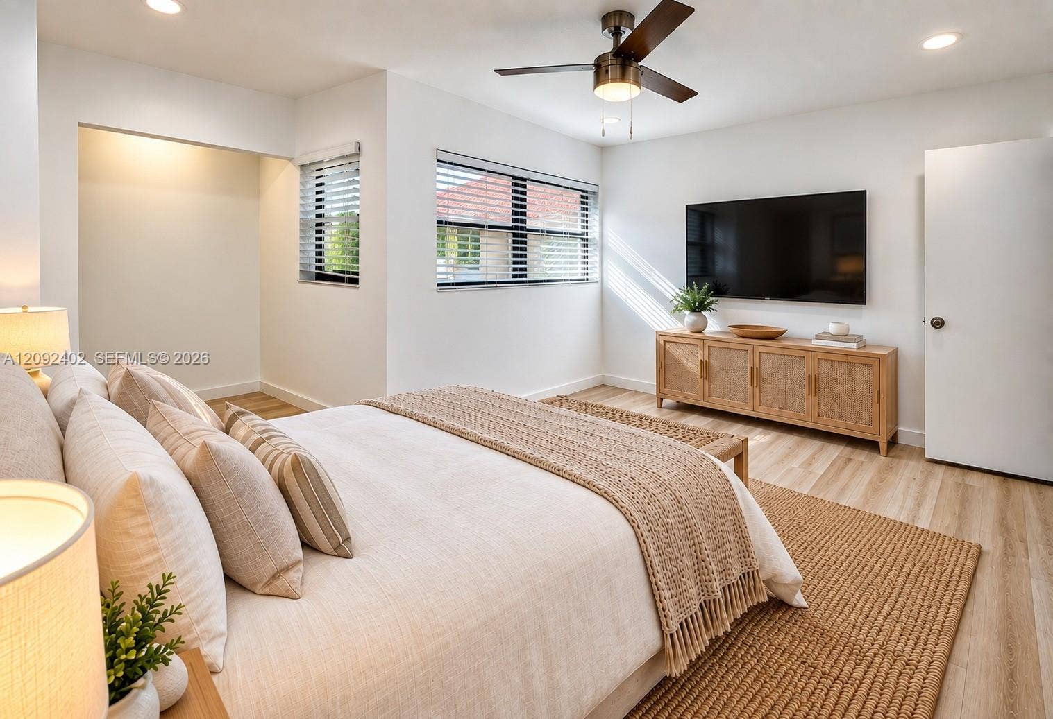 499 SE 13th Street, #7E, Fort Lauderdale, FL 33316 TV console & plants virtually staged for illustrative purposes. Interior space featuring wood-finish flooring, recessed lighting, and a ceiling fan with integrated light fixture