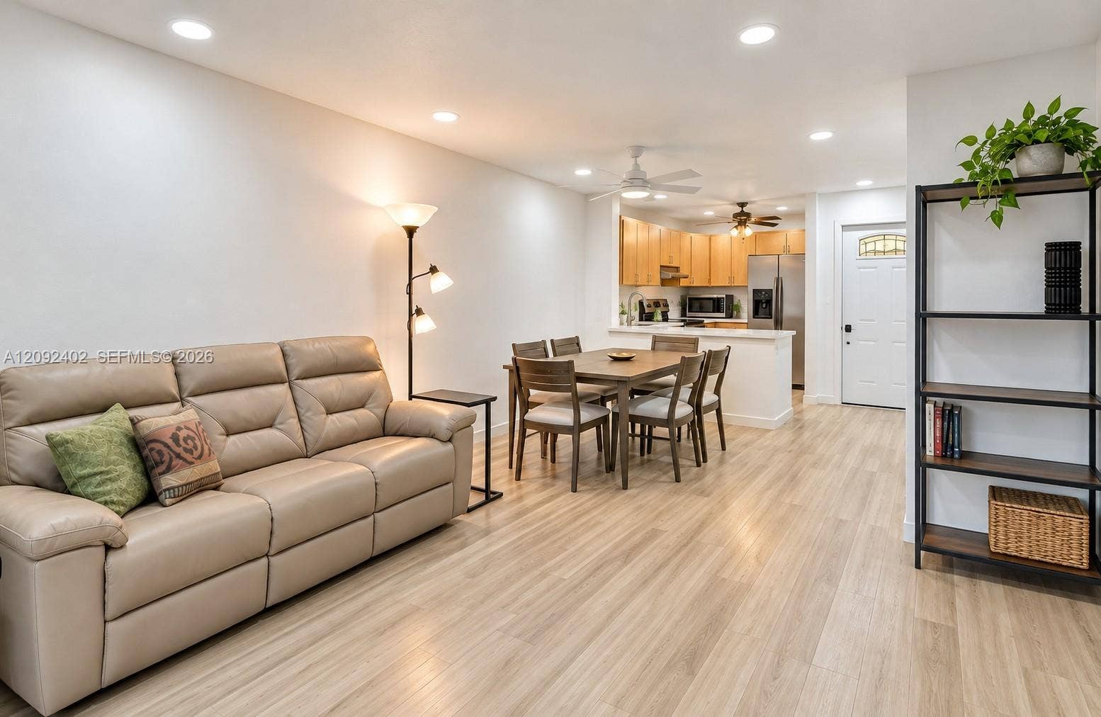 499 SE 13th Street, #7E, Fort Lauderdale, FL 33316 Open-concept interior featuring wood-finish flooring, recessed lighting, and kitchen cabinetry with stainless steel appliances