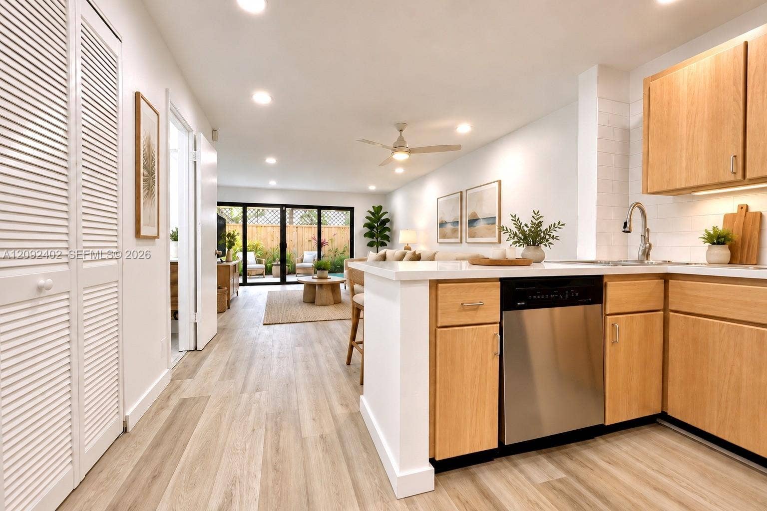 499 SE 13th Street, #7E, Fort Lauderdale, FL 33316 Virtually staged furniture. Quartz countertops, stainless steel dishwasher, wood-finish flooring, and recessed ceiling lighting.