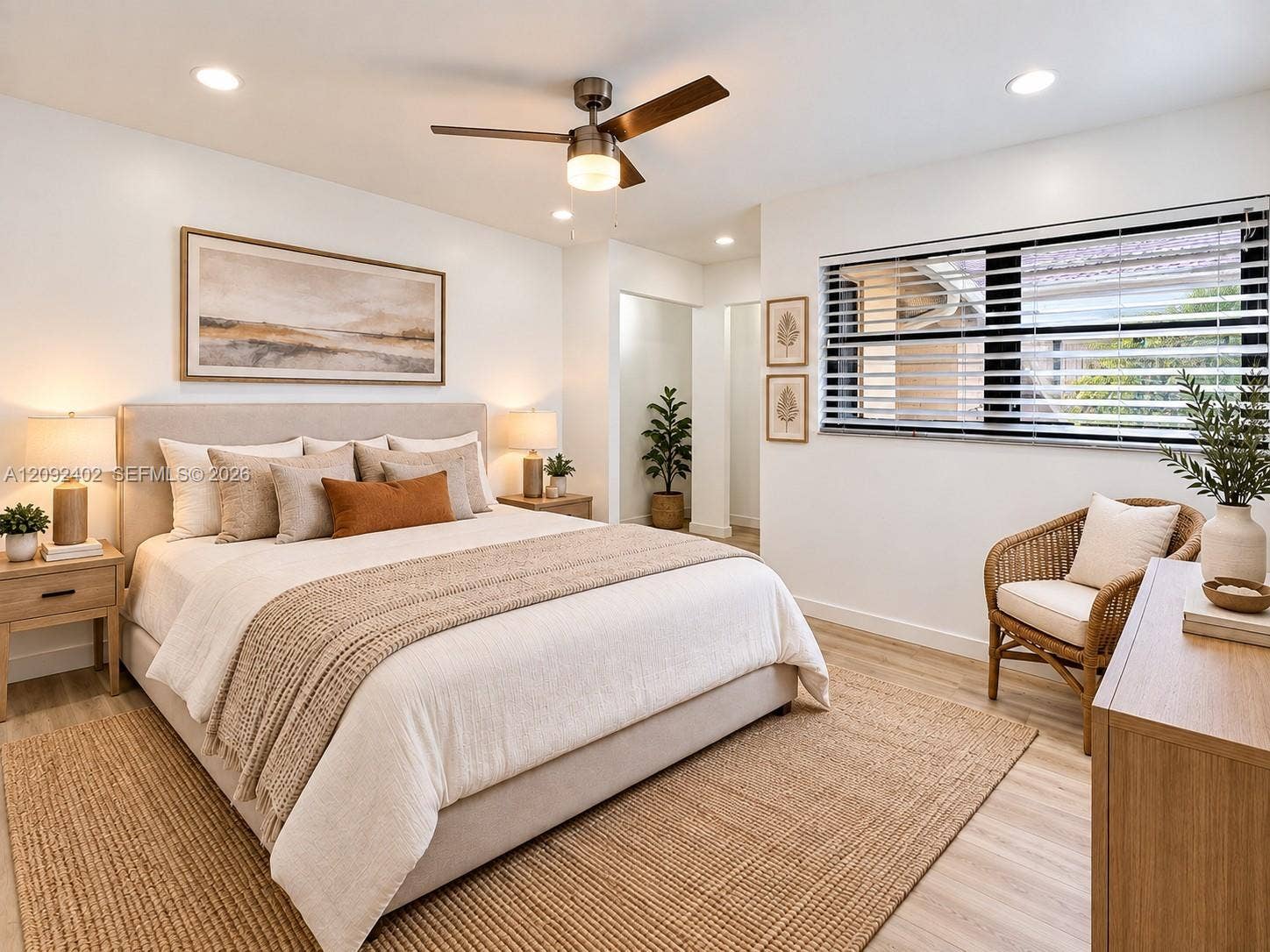499 SE 13th Street, #7E, Fort Lauderdale, FL 33316 TV console & plants virtually staged for illustrative purposes. Neutral-toned interior featuring wood-finish flooring, recessed lighting, and a modern ceiling fan with an integrated light fixture