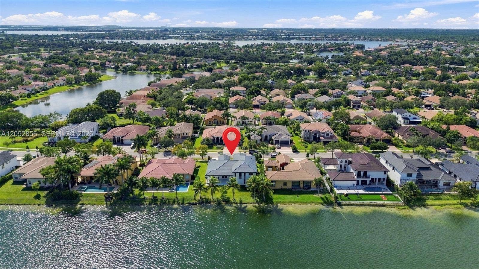 18919 SW 24th Street, #18919, Miramar, Miramar, FL 33029 Waterfront residence featuring a tiled roof, multi-level architectural exterior, and direct access to the lake