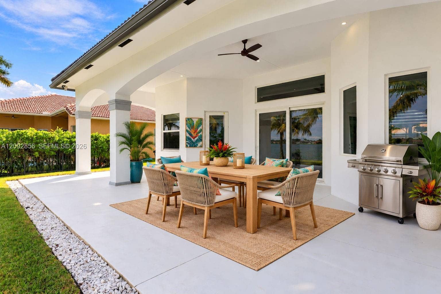 18919 SW 24th Street, #18919, Miramar, Miramar, FL 33029 Virtually staged - covered outdoor patio featuring arched architectural columns, recessed ceiling lighting, a matte black ceiling fan, and a built-in stainless steel grill