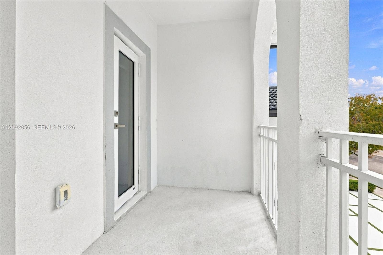 18919 SW 24th Street, #18919, Miramar, Miramar, FL 33029 5th bedroom - Covered balcony featuring stucco walls, an arched opening, and a white metal railing