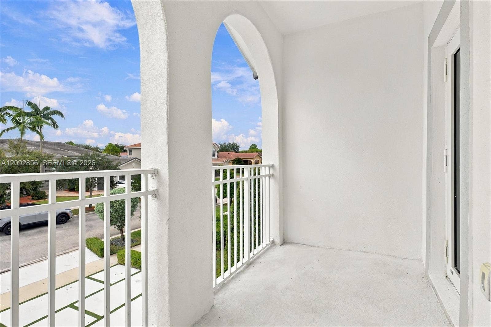18919 SW 24th Street, #18919, Miramar, Miramar, FL 33029 5th bedroom - Covered balcony featuring arched architectural detailing, a solid concrete floor, and white metal railing