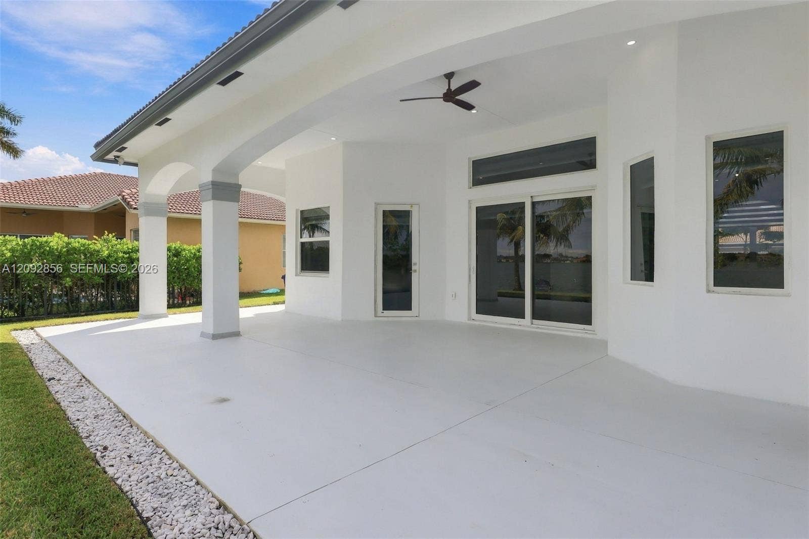 18919 SW 24th Street, #18919, Miramar, Miramar, FL 33029 Covered patio featuring arched architectural columns, recessed lighting, a ceiling fan, and sliding glass doors