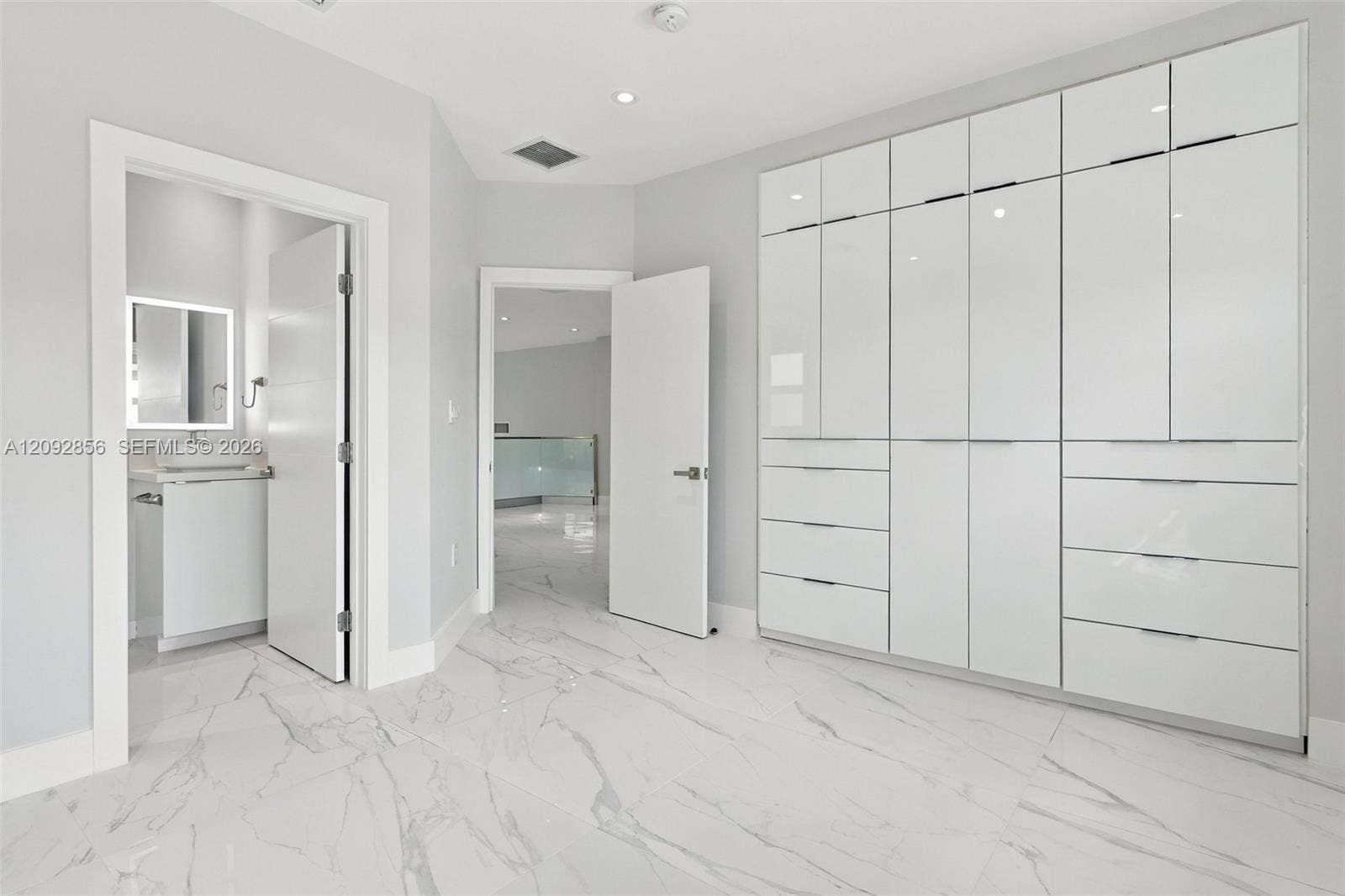 18919 SW 24th Street, #18919, Miramar, Miramar, FL 33029 4th bedroom with In suite bathroom - 2nd floor - Custom floor-to-ceiling high-gloss cabinetry, large-format stone-finish floor tiles, and recessed lighting