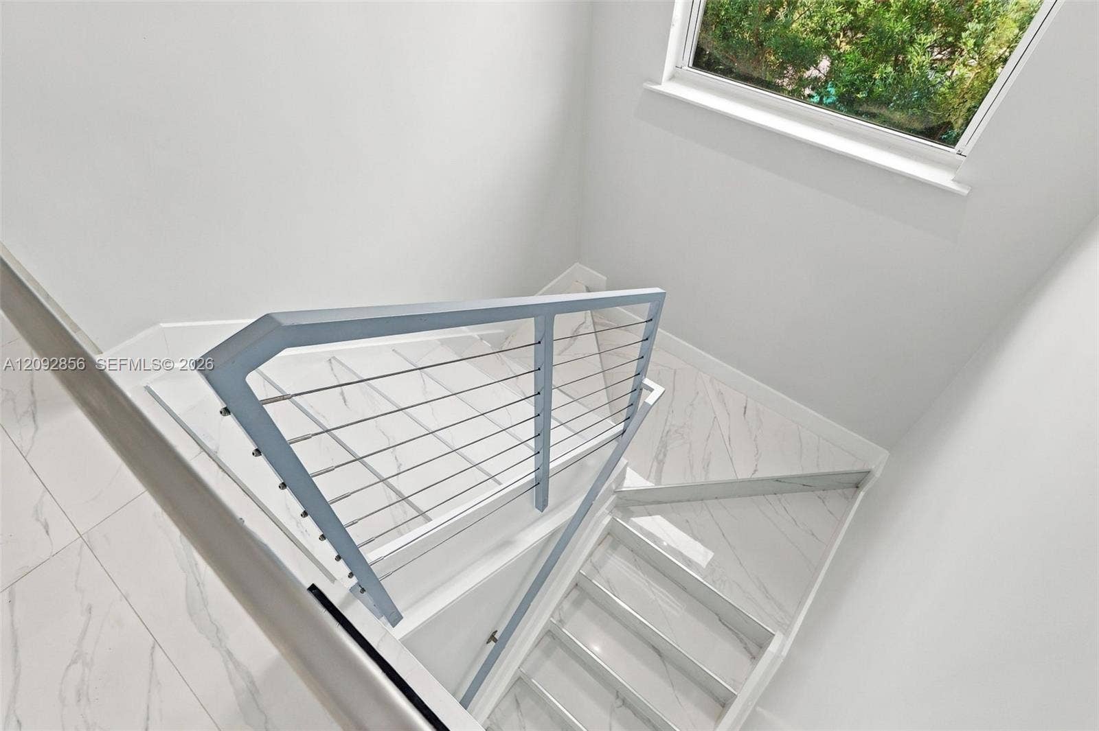 18919 SW 24th Street, #18919, Miramar, Miramar, FL 33029 Staircase featuring white stone-finish tile flooring, metal cable railing, and a window